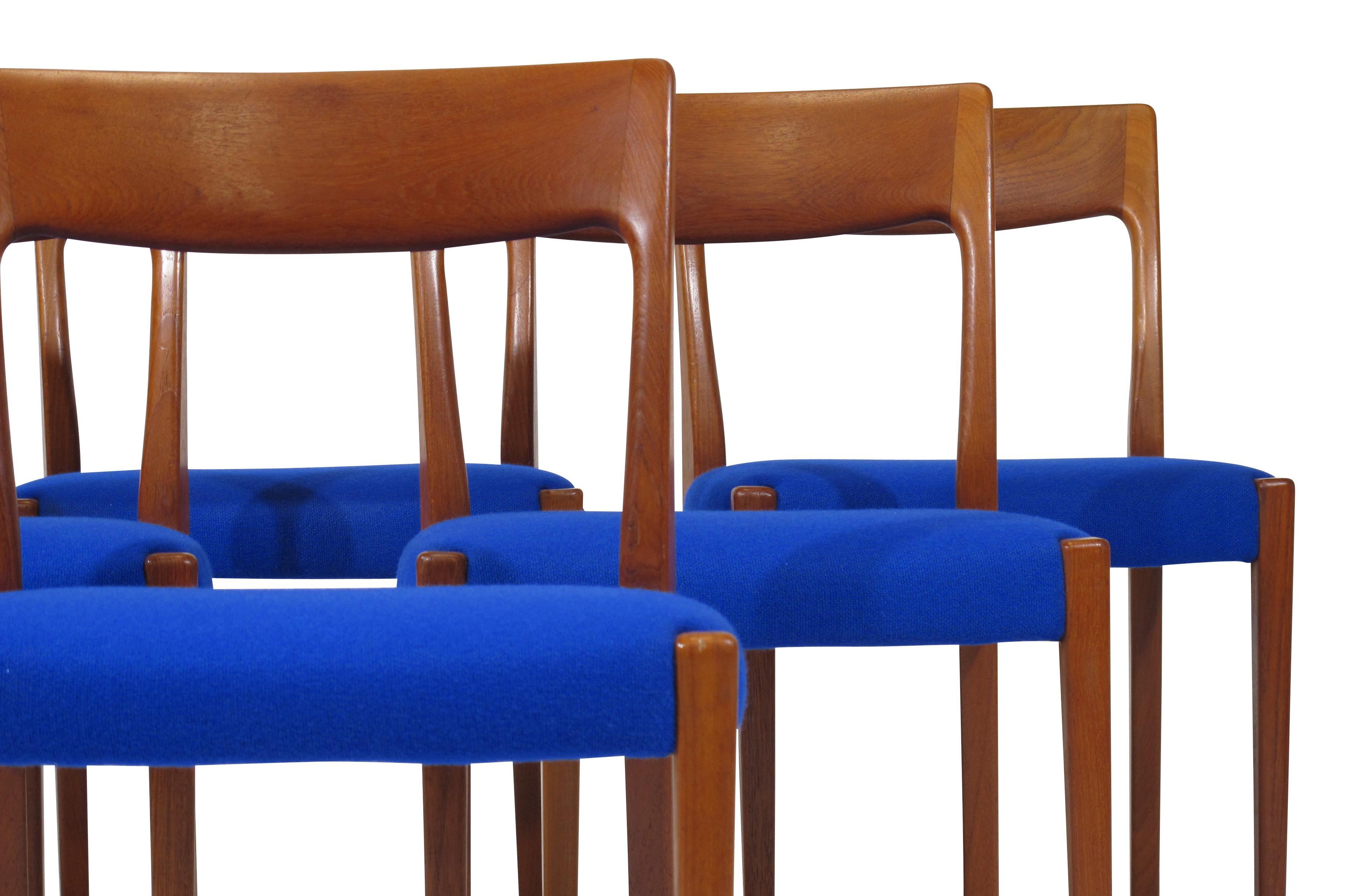 Six solid teak dining chairs with vintage blue wool seats.