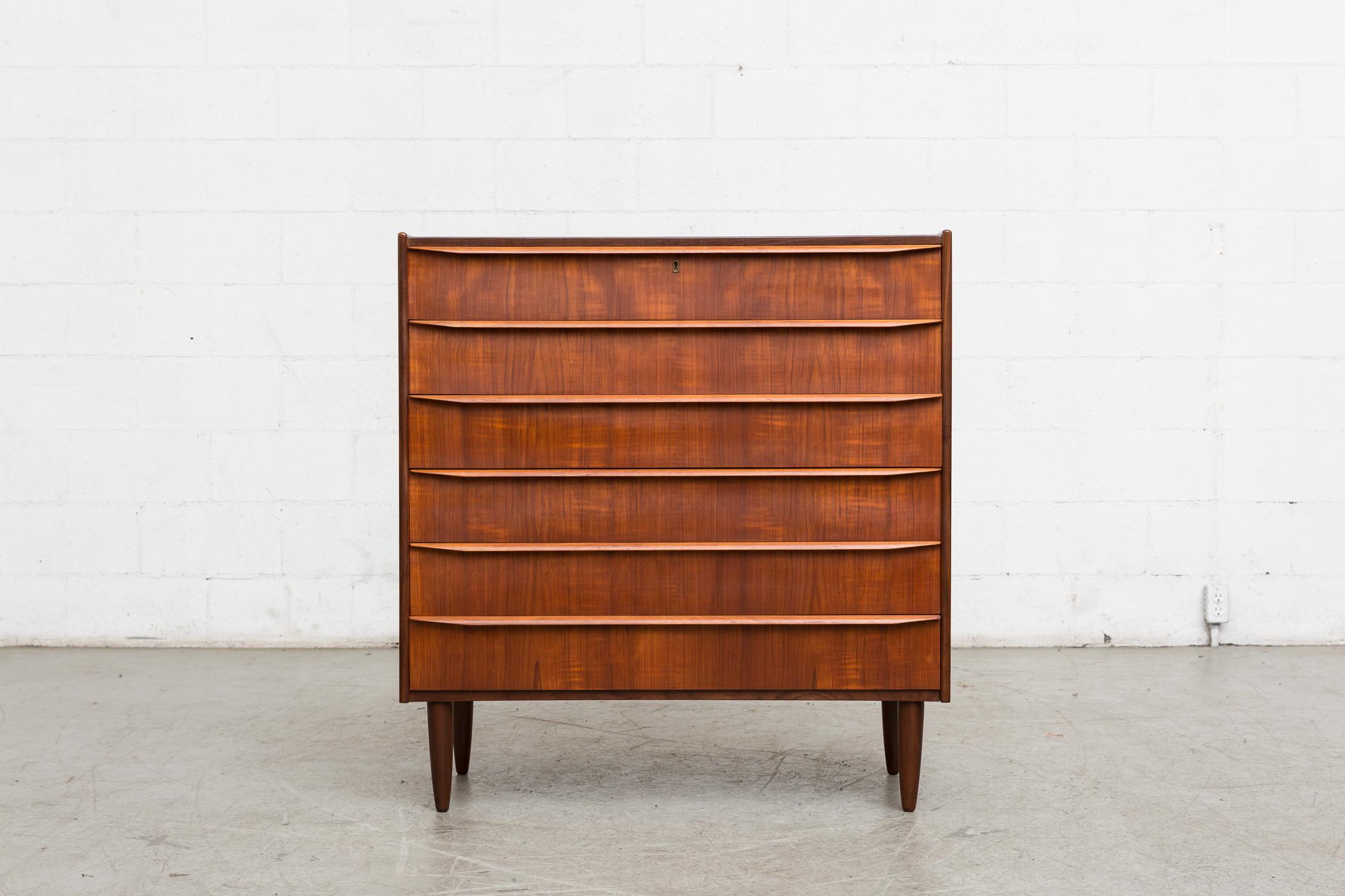 Midcentury Danish teak dresser with six drawers and organically carved linear hand pulls. Tapered legs. Lightly refinished. Good original condition, 1960s, Denmark.