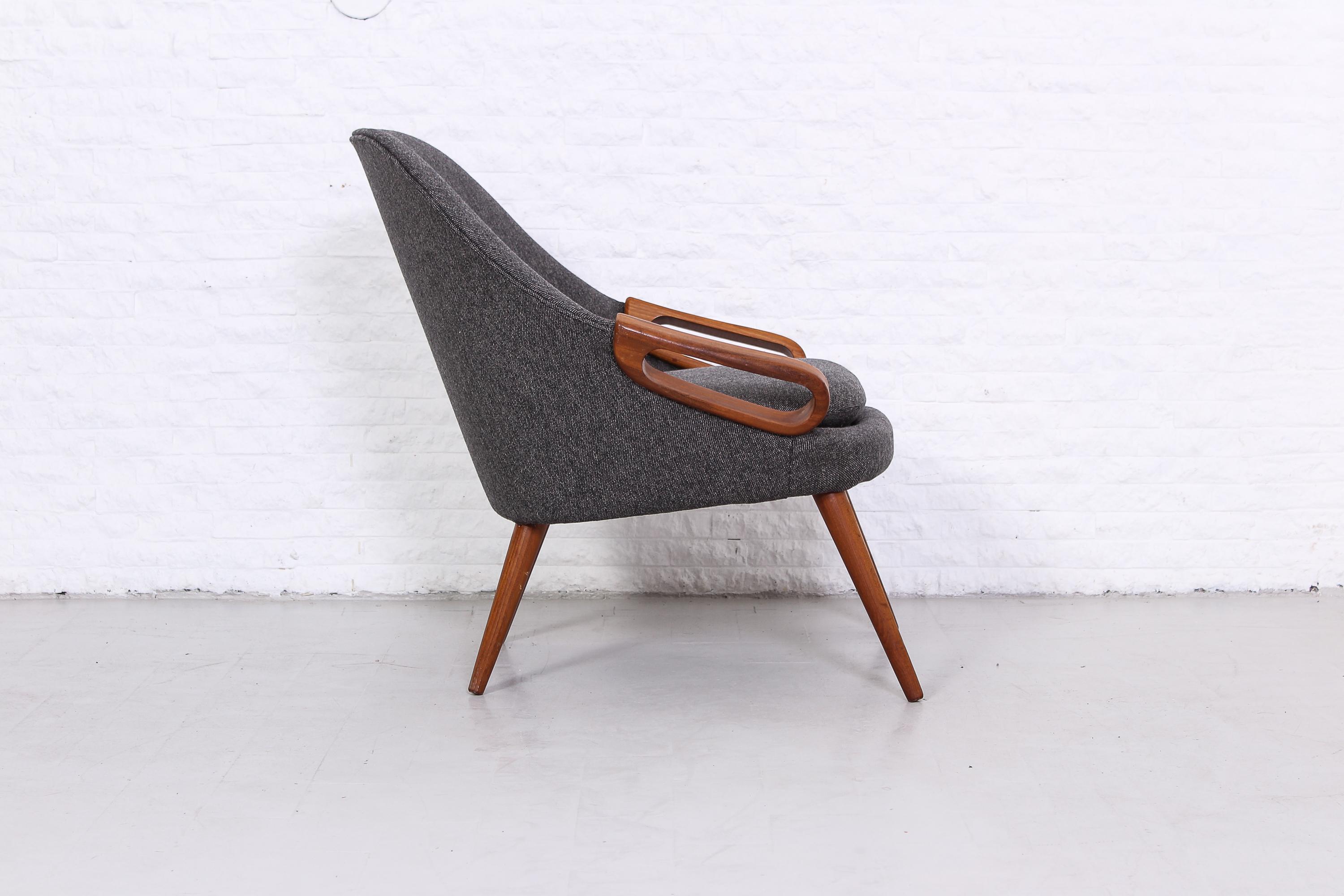 A beautiful Danish easy chair made in the 1950s. The legs and armrests are made out of teak and the chair has been reupholstered in a high quality Scandinavian wool fabric. Excellent condition.