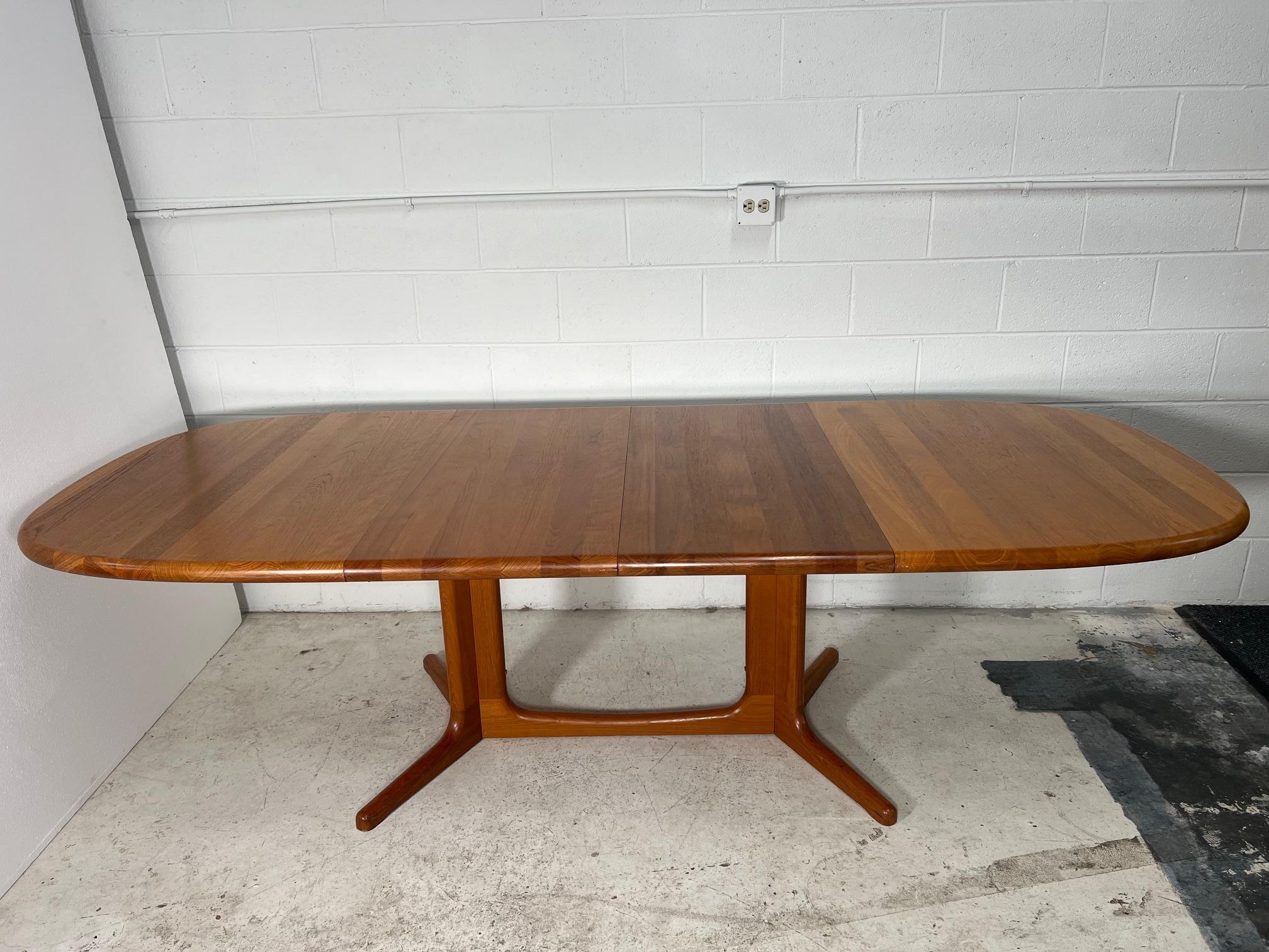 This is a Danish teak dining table with 2 leaves. Made by Glostrup Møbelfabrik. Original label still present. Leaves can be stored inside the table when not in use. The table can be extended with one or with both leaves.
It seats 10 people