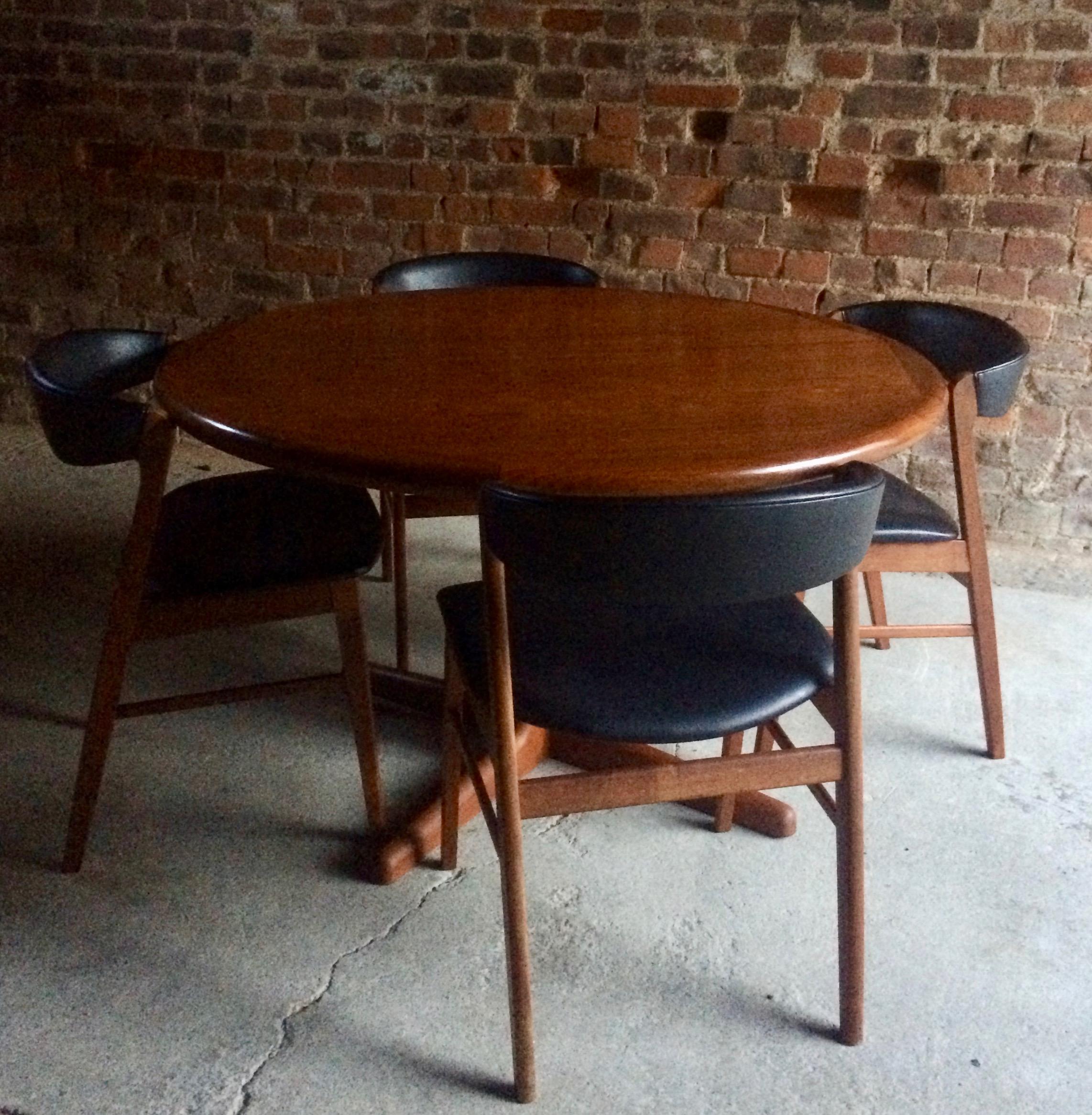 Midcentury Danish solid teak extending dining table, circa 1970s, the circular two section D shaped top over twin pedestal base, extending with two leaves to three sizes to accommodate from 4 to 6 to 8 people, the table disassembles with the top,