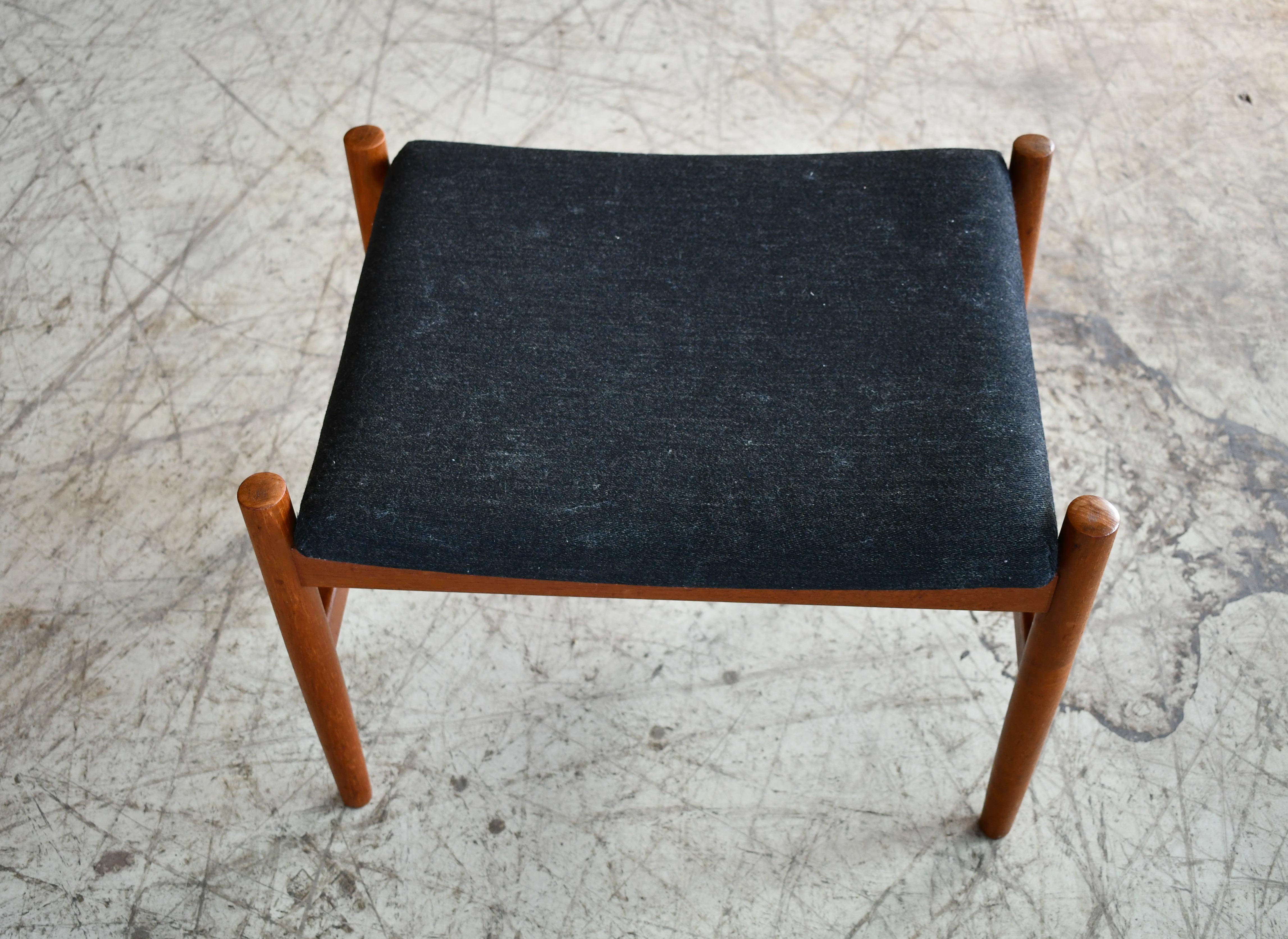 Spottrup's Classic and sought after ottoman featuring a solid teak frame and a fabric cushion. A great Danish midcentury design that could be paired with a chair as an ottoman or used alone as a stool. Overall very good condition. We offer