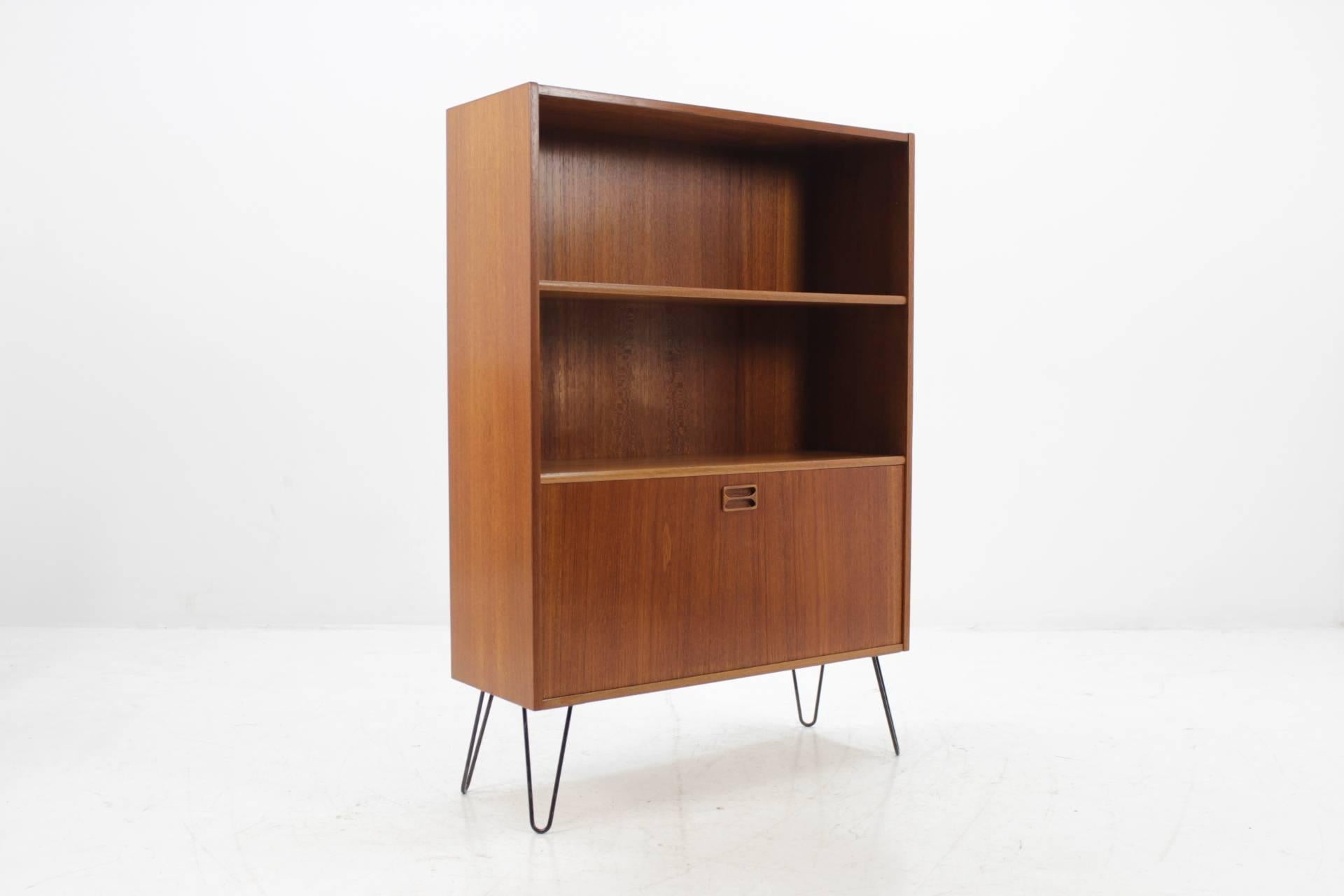 This Danish teak cabinet features two shelves and one compartment with door. This item was carefully restored.