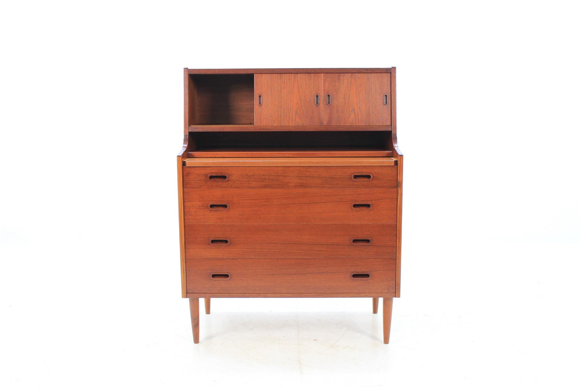 This Danish teak writing cabinet features mirror, four large drawers and two sliding doors with inner shelves. The extendable writing area desk can be extended up to 73 cm. This item was carefully refurbished.