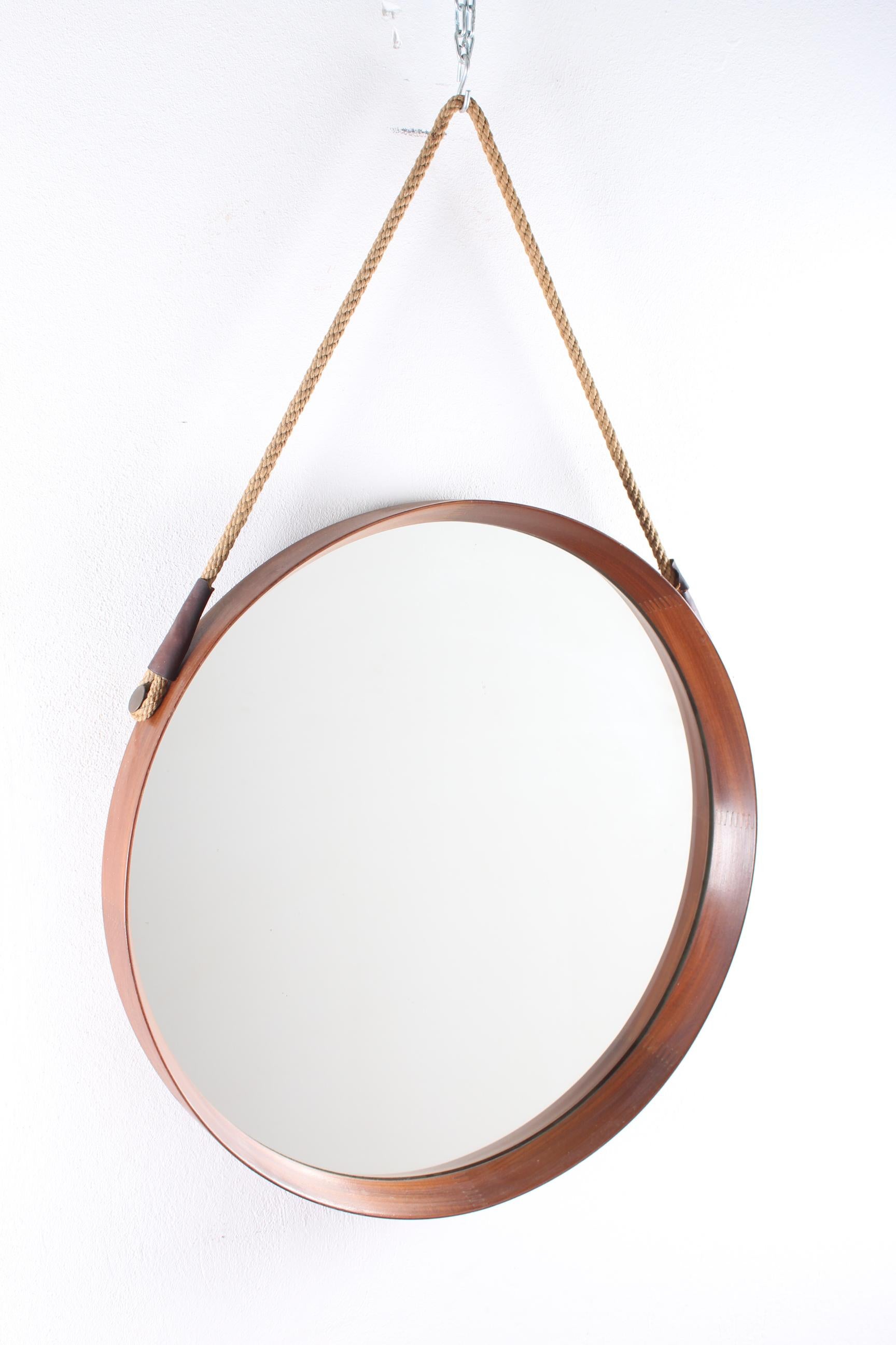 Round mirror with dark brown frame, Italy, 1960s.
Wear consistent with age and use.