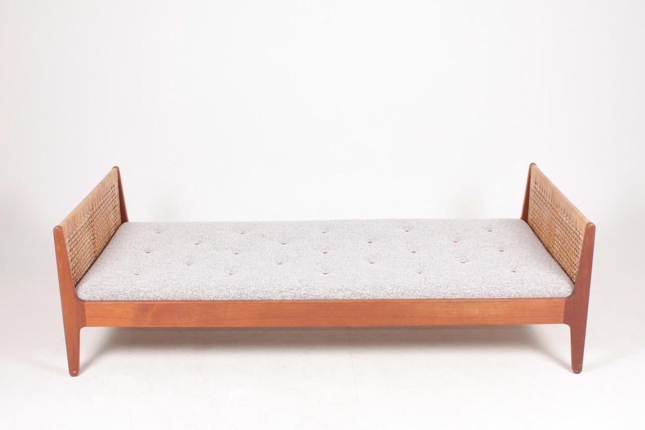 Daybed in teak with new bouclé mattress and leather buttons, designed and made in Denmark. Great condition.