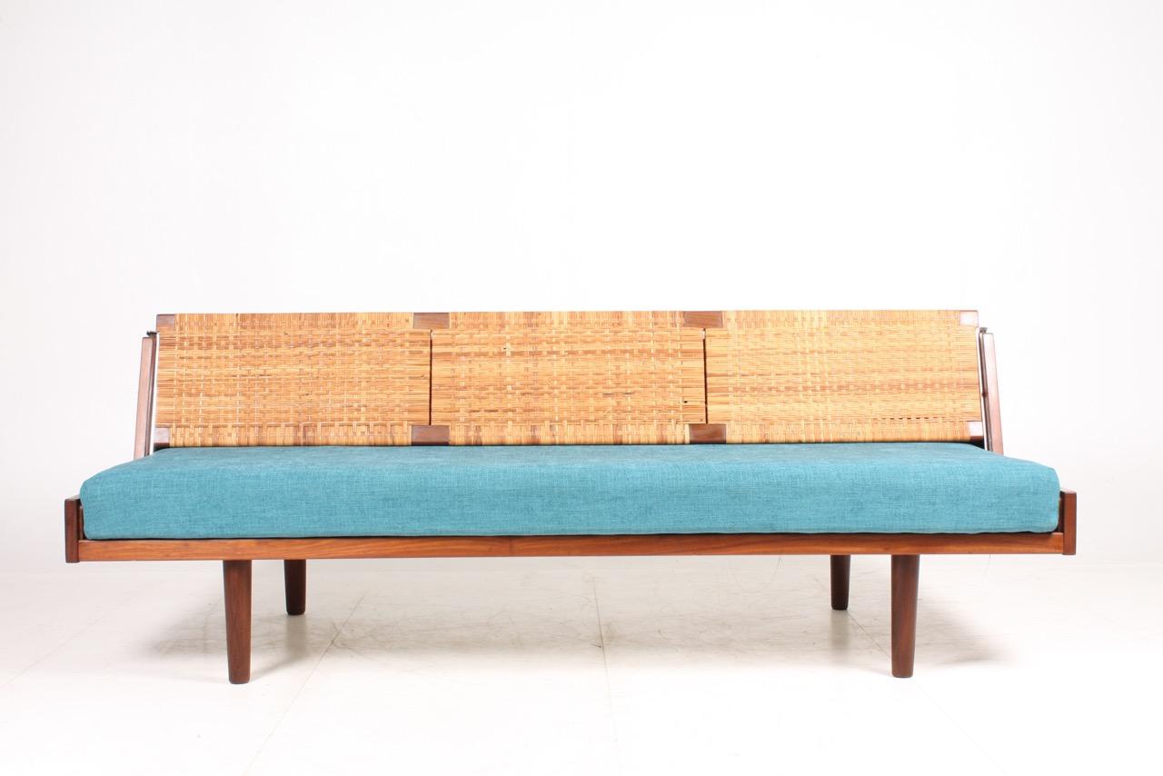 Hans J. Wegner GE259 daybed in teak. New upholstery. Flip back in cane. 
Manufactured by GETAMA, Gedsted.