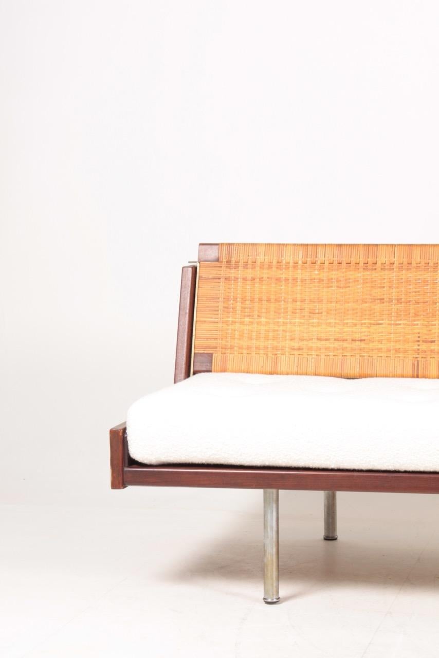 Hans J. Wegner GE259 daybed in teak. New upholstery. Flip back in cane. 
Manufactured by GETAMA, Gedsted.