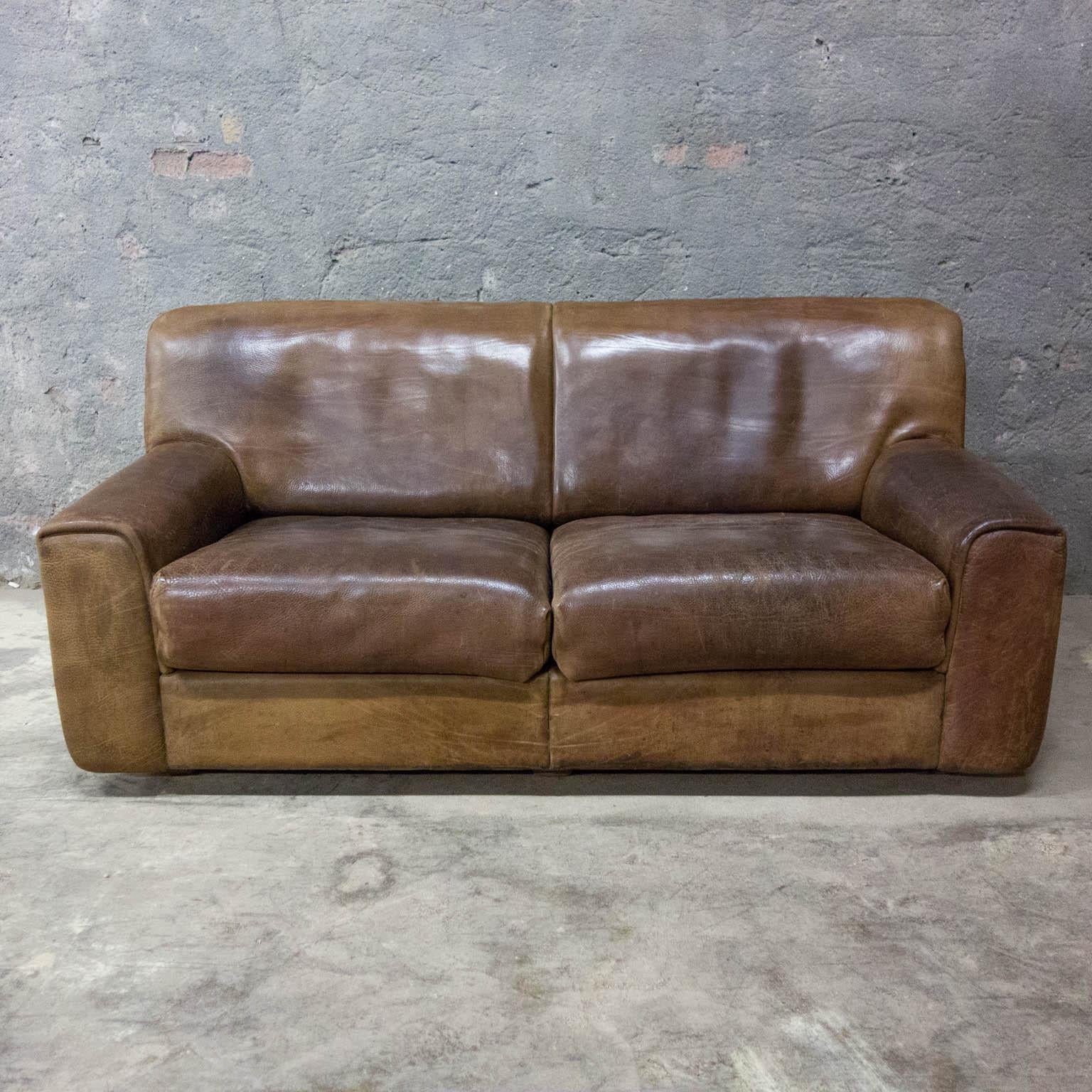 A beautiful midcentury leather sofa from De Sede. The beautifully patinated thick leather of the DS-42 is in good condition and will last for years. Under the removable seat cushions, the De Sede marks can be seen (see photos). Even after almost 50