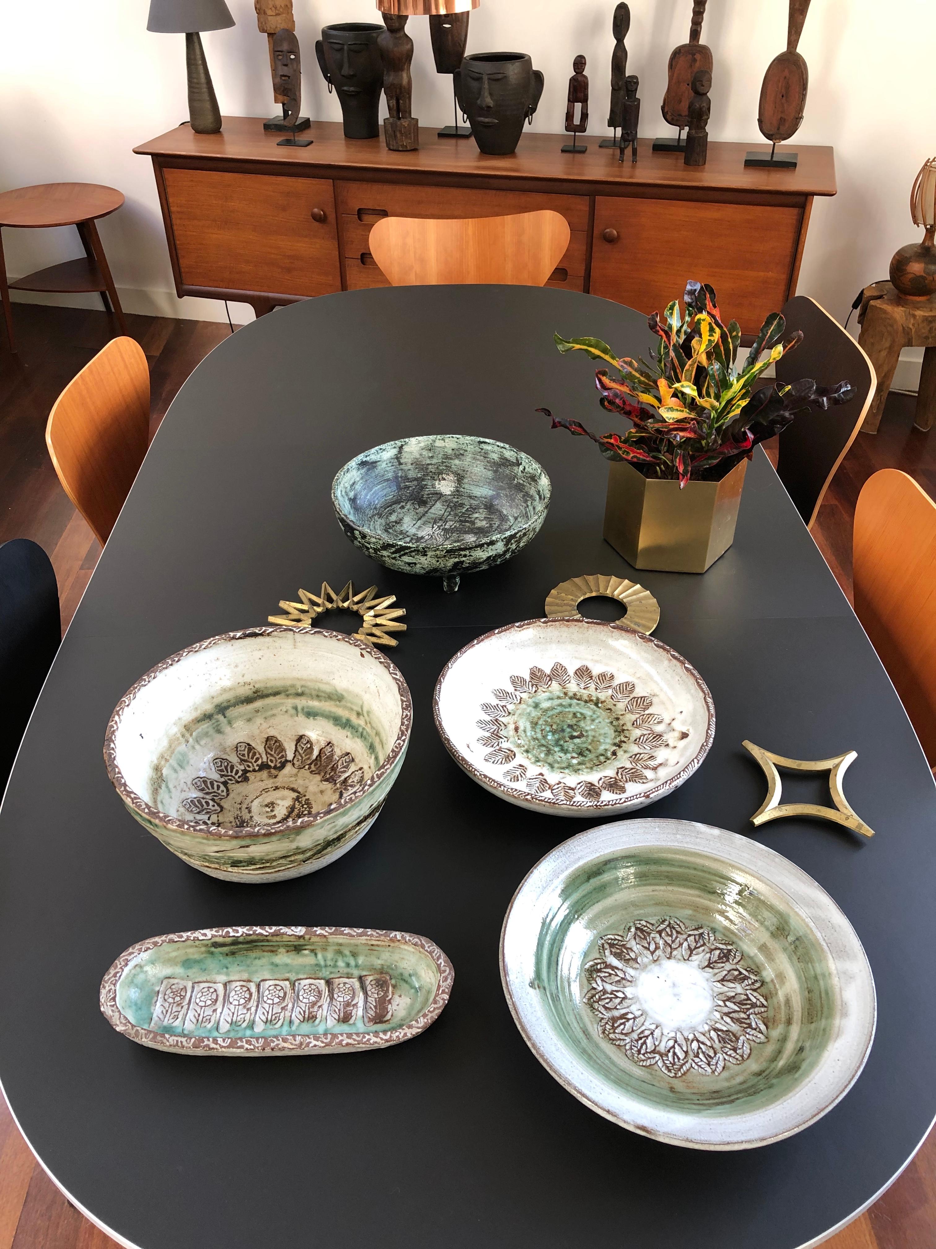 Midcentury decorative plate, circa 1960s by Albert Thiry (1932-2009). A green glazed central sphere is encircled by deeply engraved leaves in brown over a hazy white surface. The leaf motif is repeated on the lip of the dish making this piece not