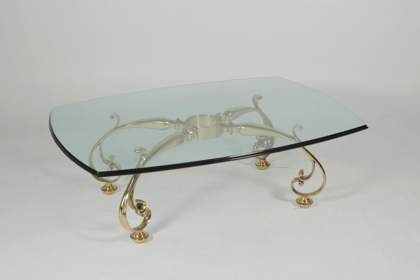 Midcentury decorative solid brass cocktail, coffee table with bevelled edged glass top the solid cast base with graceful curled legs with central round support ring.