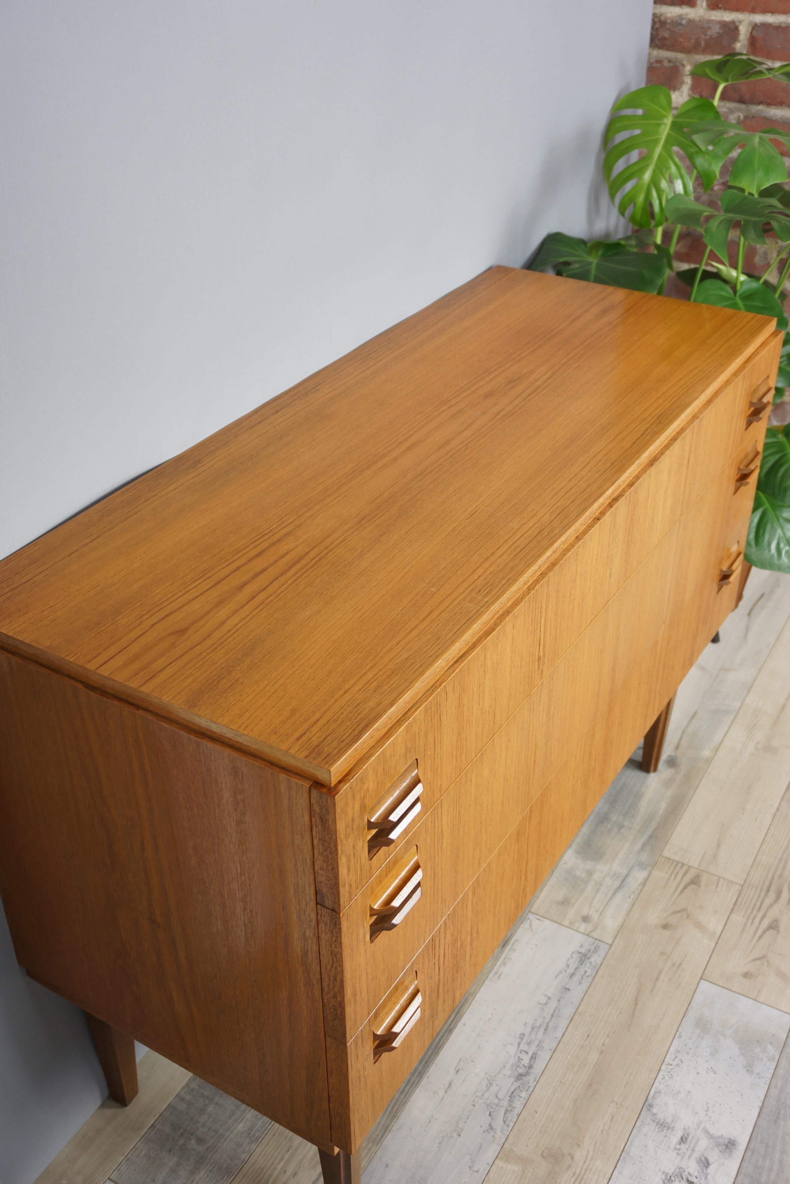 Teak wooden chest of drawers Scandinavian design from the 1960s, beautiful and practical. Sign of fine, delicate and quality work: its sculpted handles and feet just like the interior of wooden drawers. All in excellent condition.