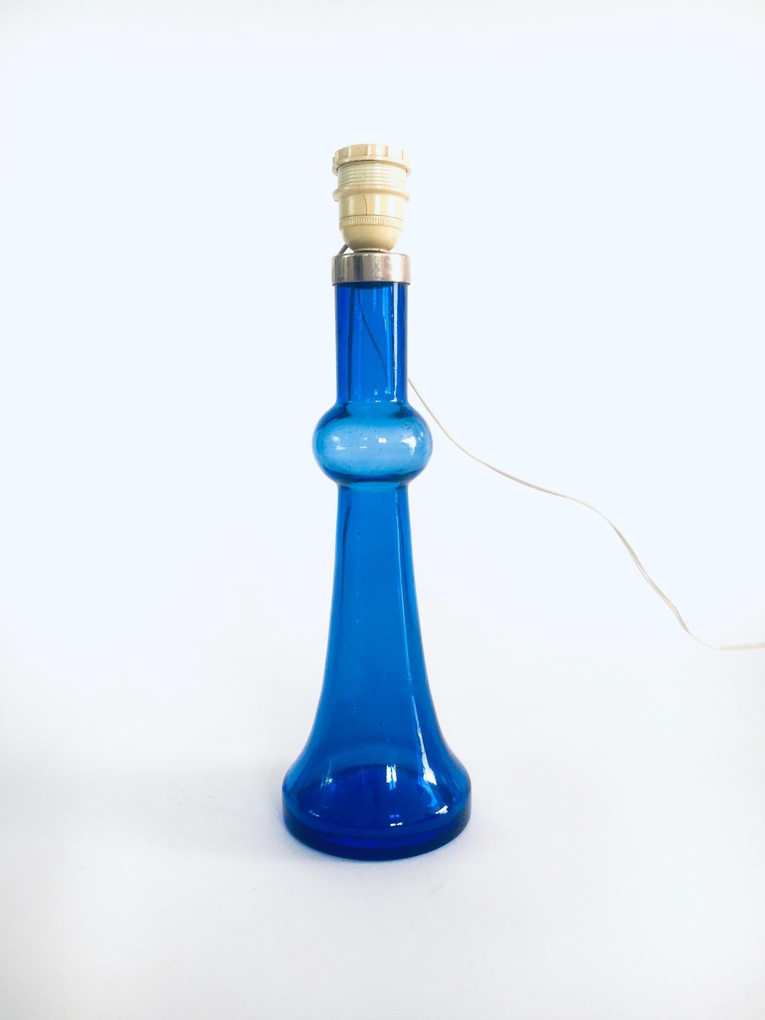 Vintage Midcentury Design Blaue Glastischlampe von Nanny Still für Raak, Amsterdam, Niederlande, 1960er / 70er Jahre. Blau gefärbter Glasfuß mit Originalbeschlägen. Handgefertigtes Glas. Es ist in sehr gutem, originalem Zustand. Maße (ohne Schirm)