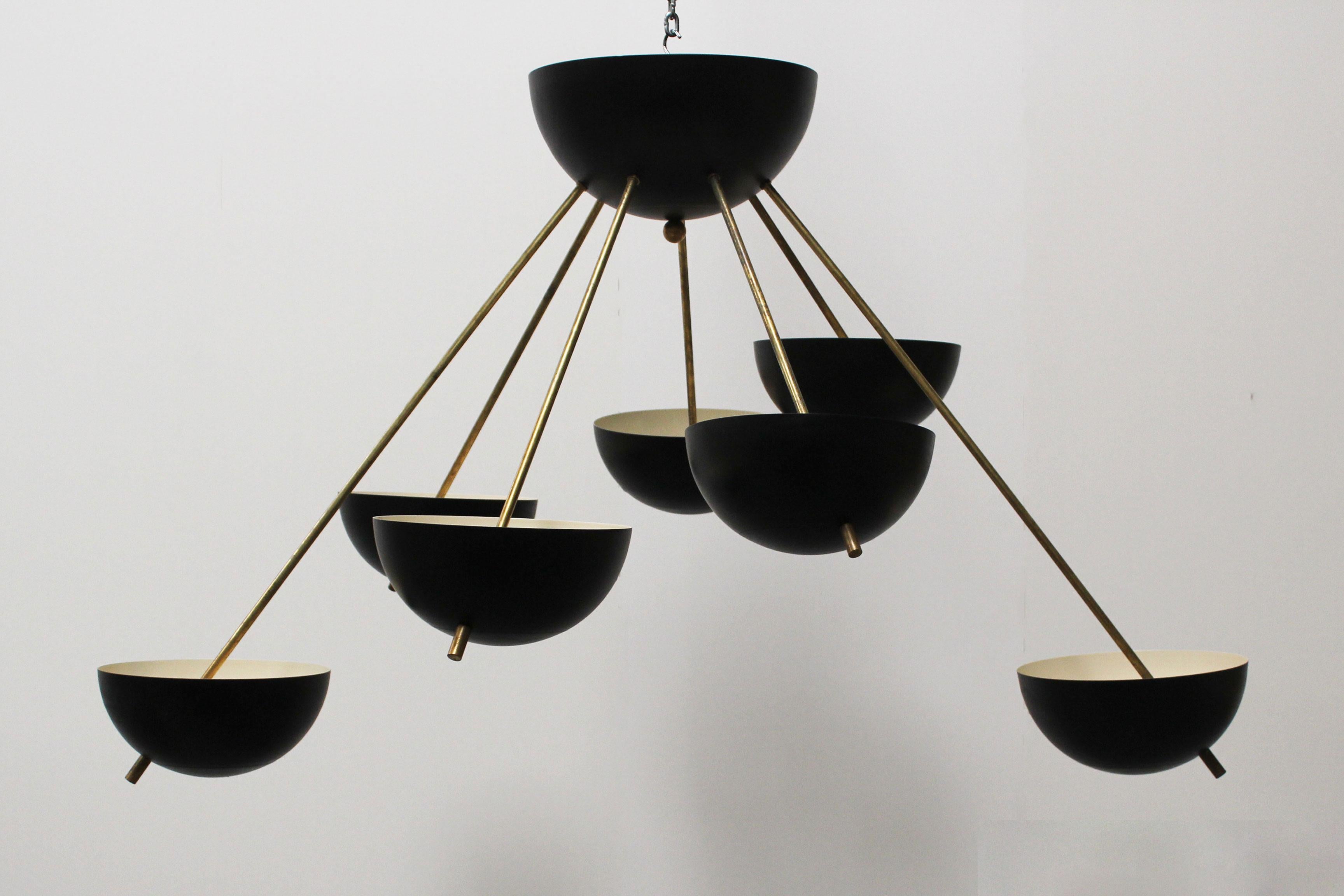 Magnificent midcentury design Sputnik chandelier in design of 1960s Stilnovo.
It has a wonderful minimalistic Stilnovo design with lines inspired by the Space Age.
The chandelier has seven sockets and is fully rewired. Brass shows small sings of