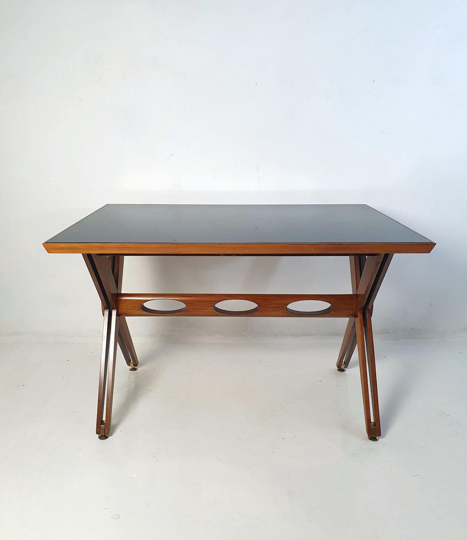This writing desk, proudly crafted in Italy, embodies the timeless aesthetics of the Mid-Century design movement prevalent during the 1950s. Its exquisite design showcases the designer's impeccable sense of form and harmony. The base of the desk,
