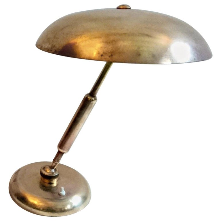 Desk made in Italy in brass with two adjustable points to adjust the position of the lamp. Has a heavy base to support the angle of the lamp.