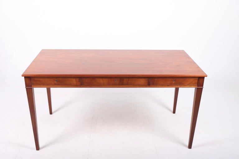 Freestanding desk in mahogany with three drawers, designed and made by cabinetmaker Frits Henningsen. Made in Denmark, great original condition.