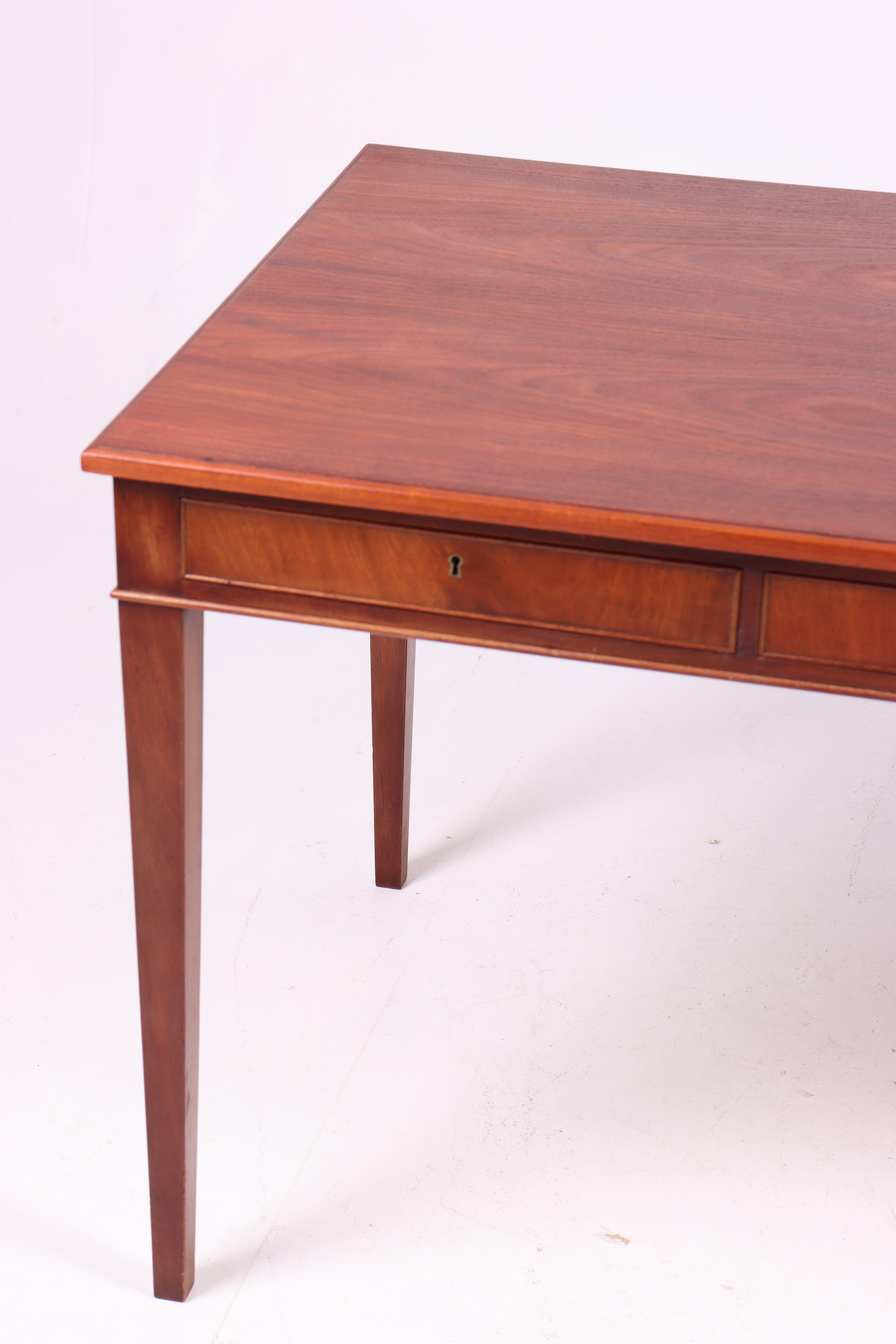 Freestanding desk in mahogany with three drawers, designed and made by cabinetmaker Frits Henningsen. Made in Denmark, great original condition.