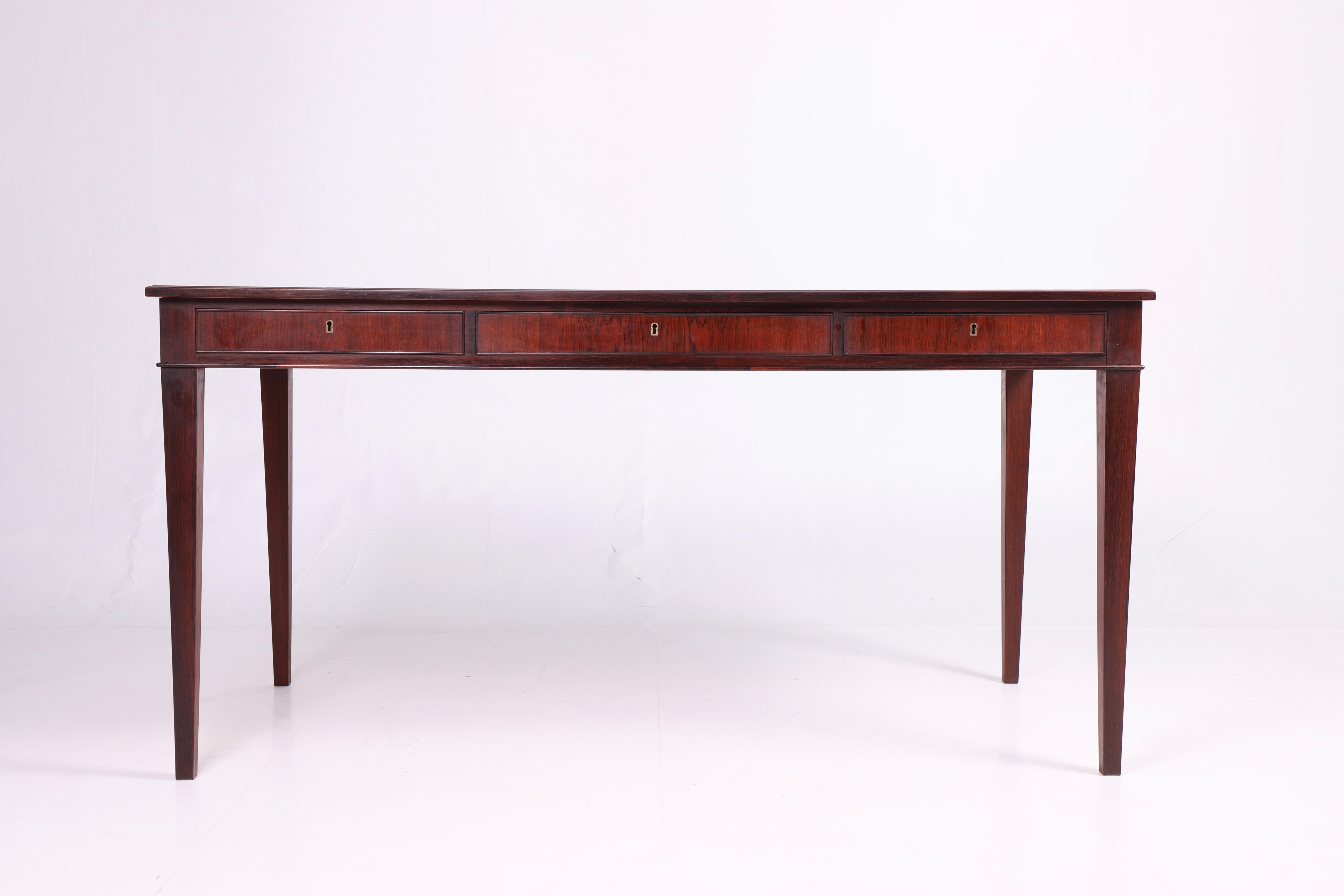 Freestanding desk in rosewood with three drawers, designed and made by cabinetmaker Frits Henningsen. Made in Denmark, great original condition.