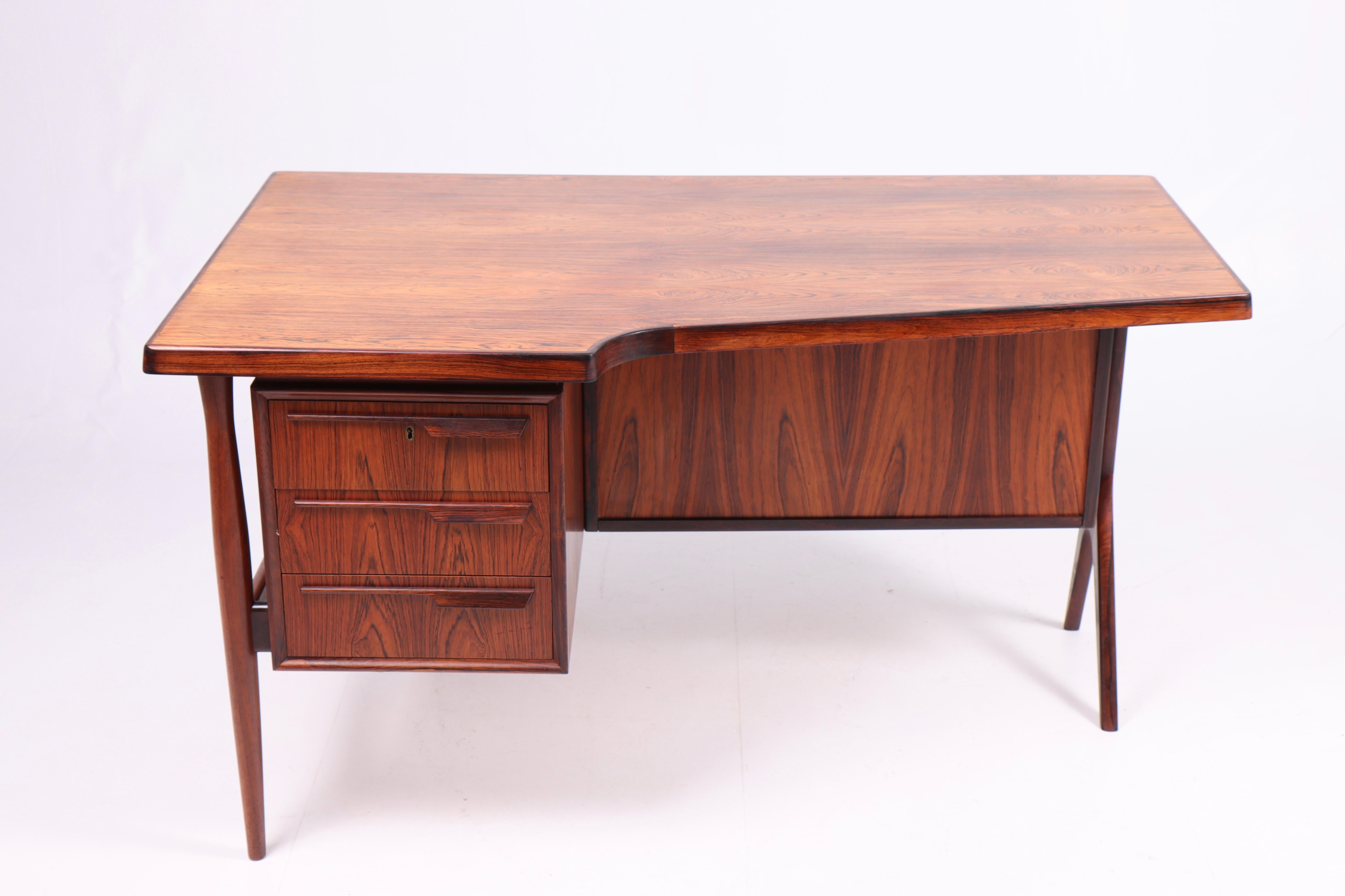 Great looking desk in rosewood. Designed by and made in Denmark in the 1950s. Nice original condition.
