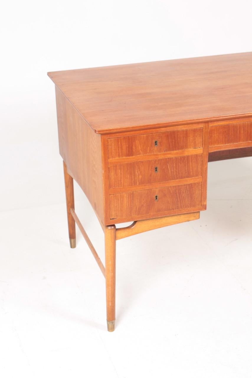 Freestanding desk in teak with solid oak frame, designed and made in Denmark in the 1960s. Great condition.