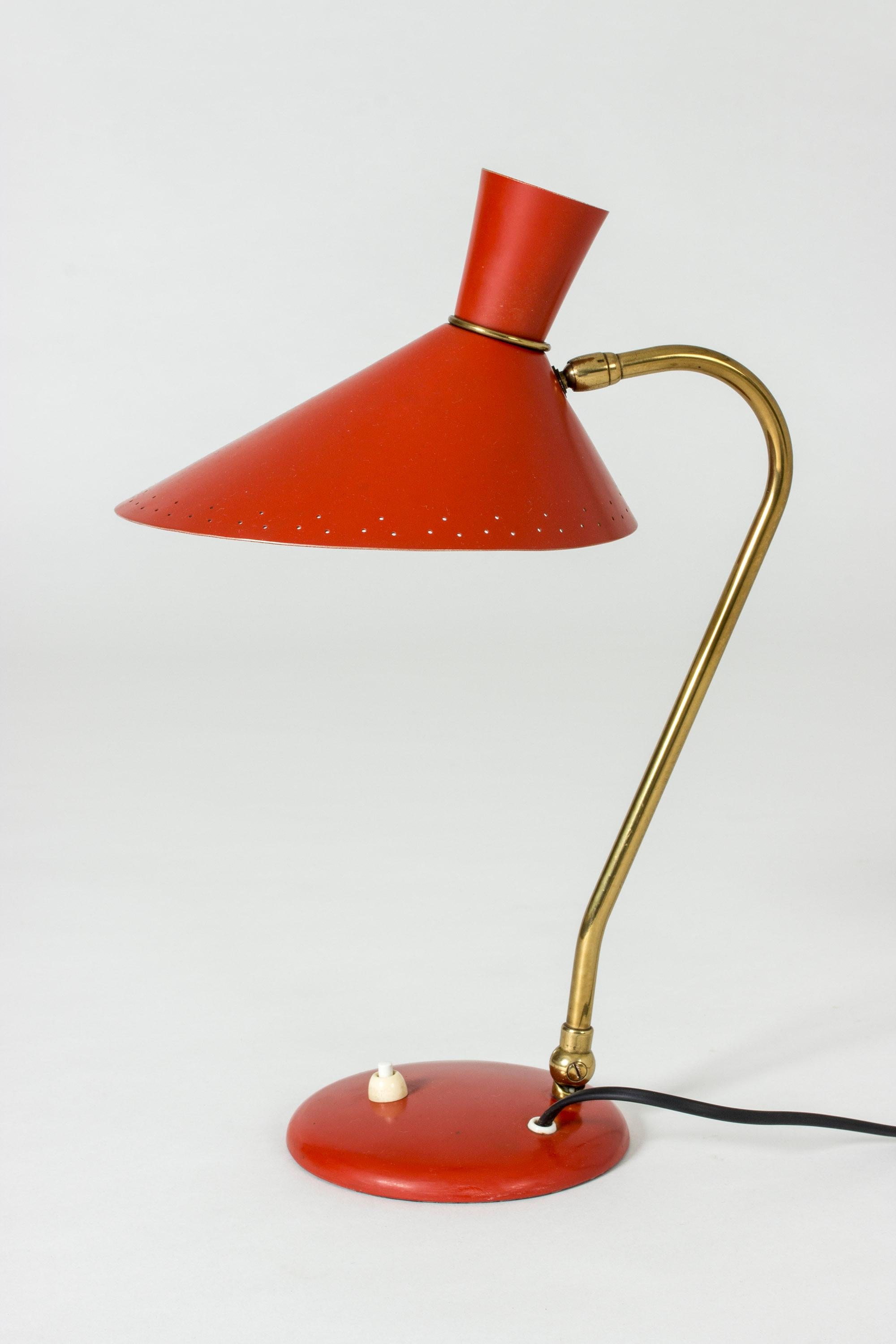 Very neat table lamp by Svend Aage Holm Sørensen, made from metal with original red lacquer. Nice pattern of punched out holes around the edge of the shade.