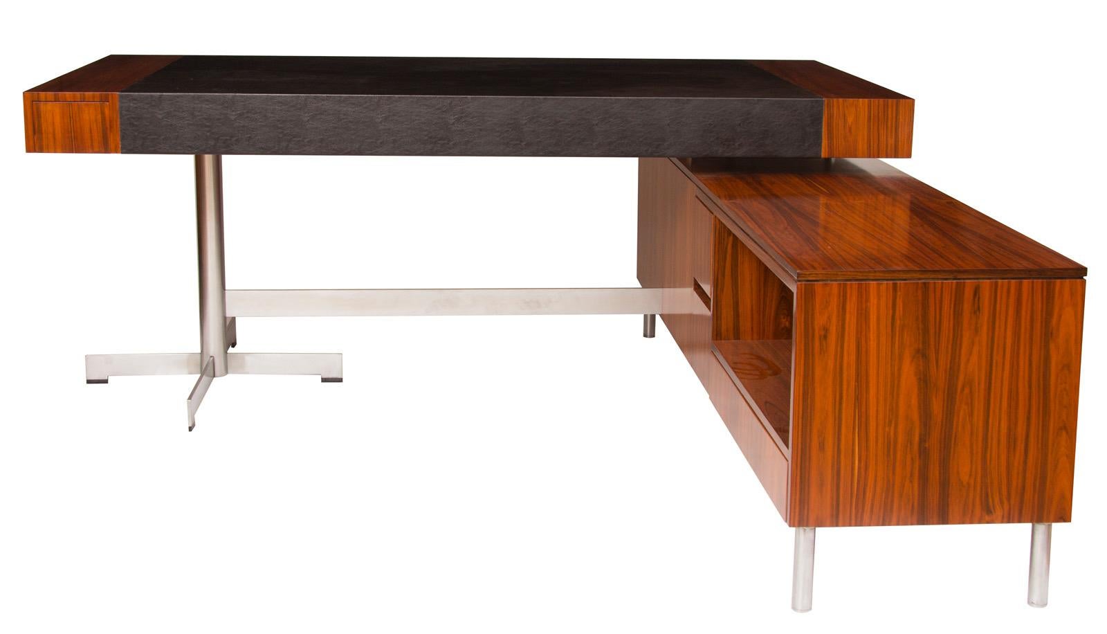 Midcentury rosewood desk.
Large midcentury rosewood and chrome desk L shape desk unit with large leather writing area, in the Manner of Merrow Associates.
I am attributing this to Merrow Associates because of the flat chrome legs which have the