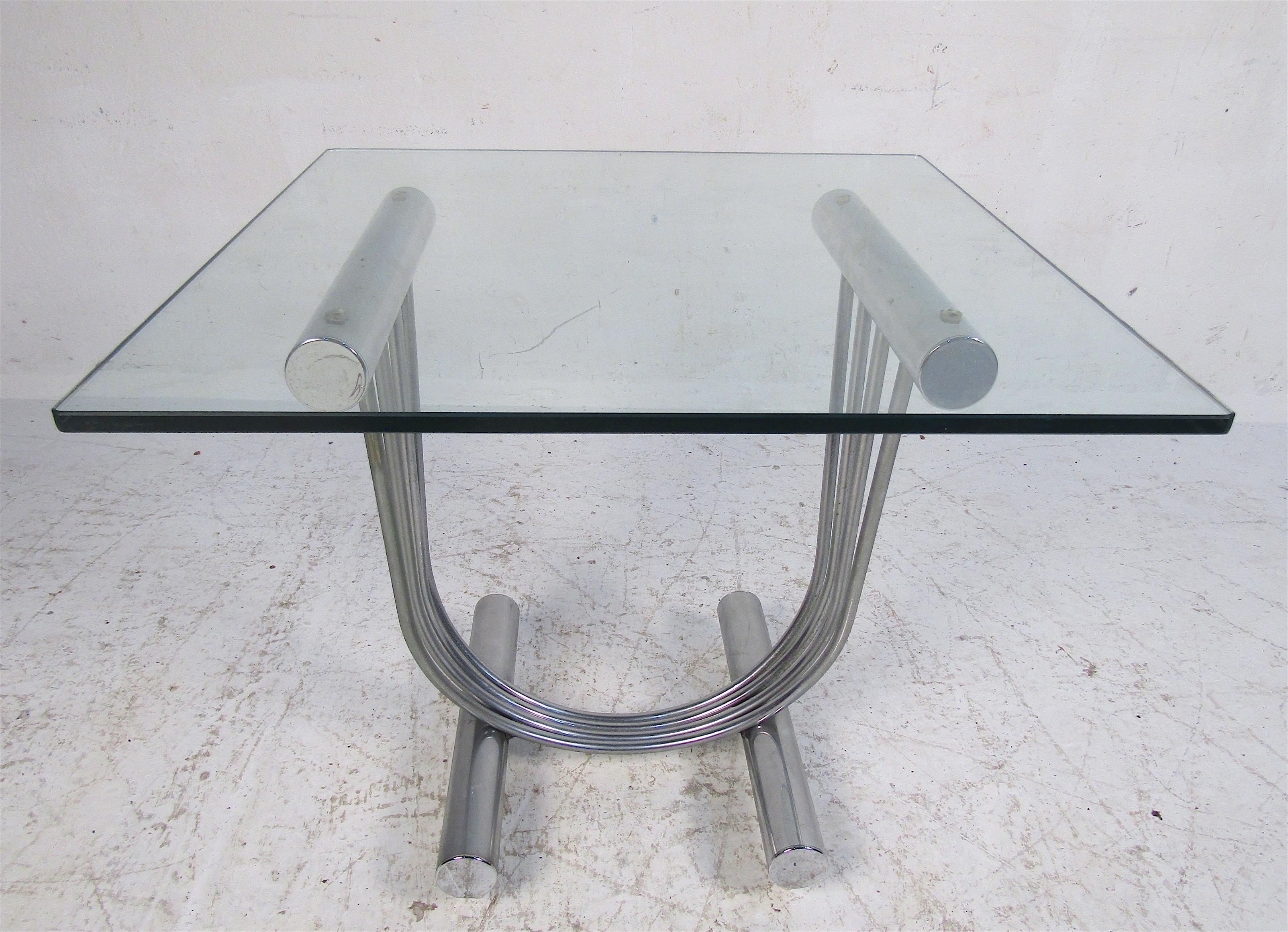 This beautiful vintage pair of modern side tables feature a chrome harp shaped base and a thick square glass top. A sleek and sturdy design that is sure to complement any modern interior. In the style of Design Institute of America. Please confirm
