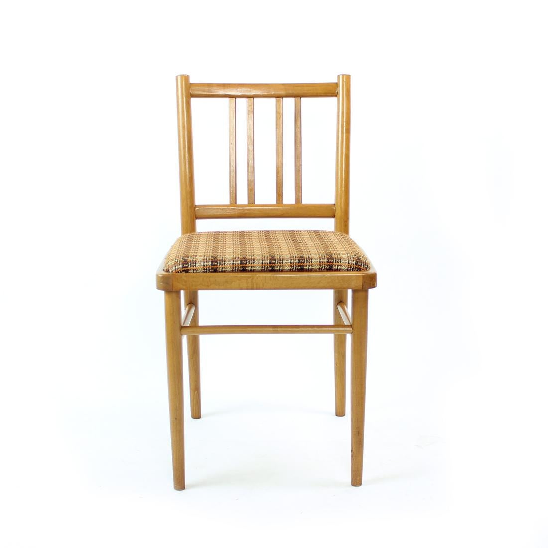 Beautiful set of 4 dining chairs. Produced in 1960s by TON in Czechoslovakia. The chairs are made of strong oak wood in blond shade of wood. The seat is upholstered in an original fabric. The design of the chairs shows typical features of the