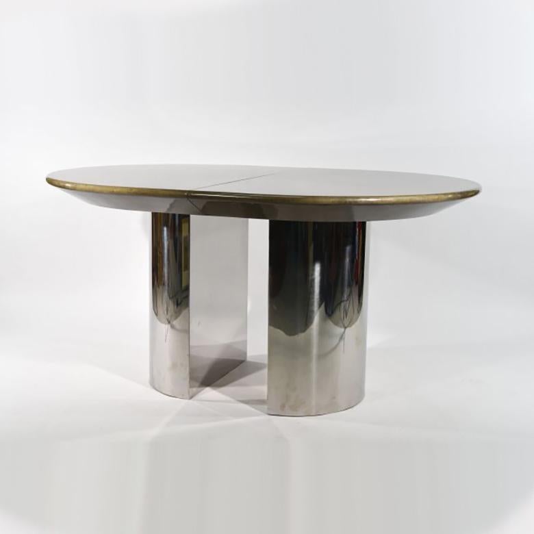 This is a beautiful vintage dining table attributed to the famous New York designer Karl Springer.
Sitting on chromed steel bases, the top is made of lacquered goatskin with a table leaf allowing to expand the length to 84