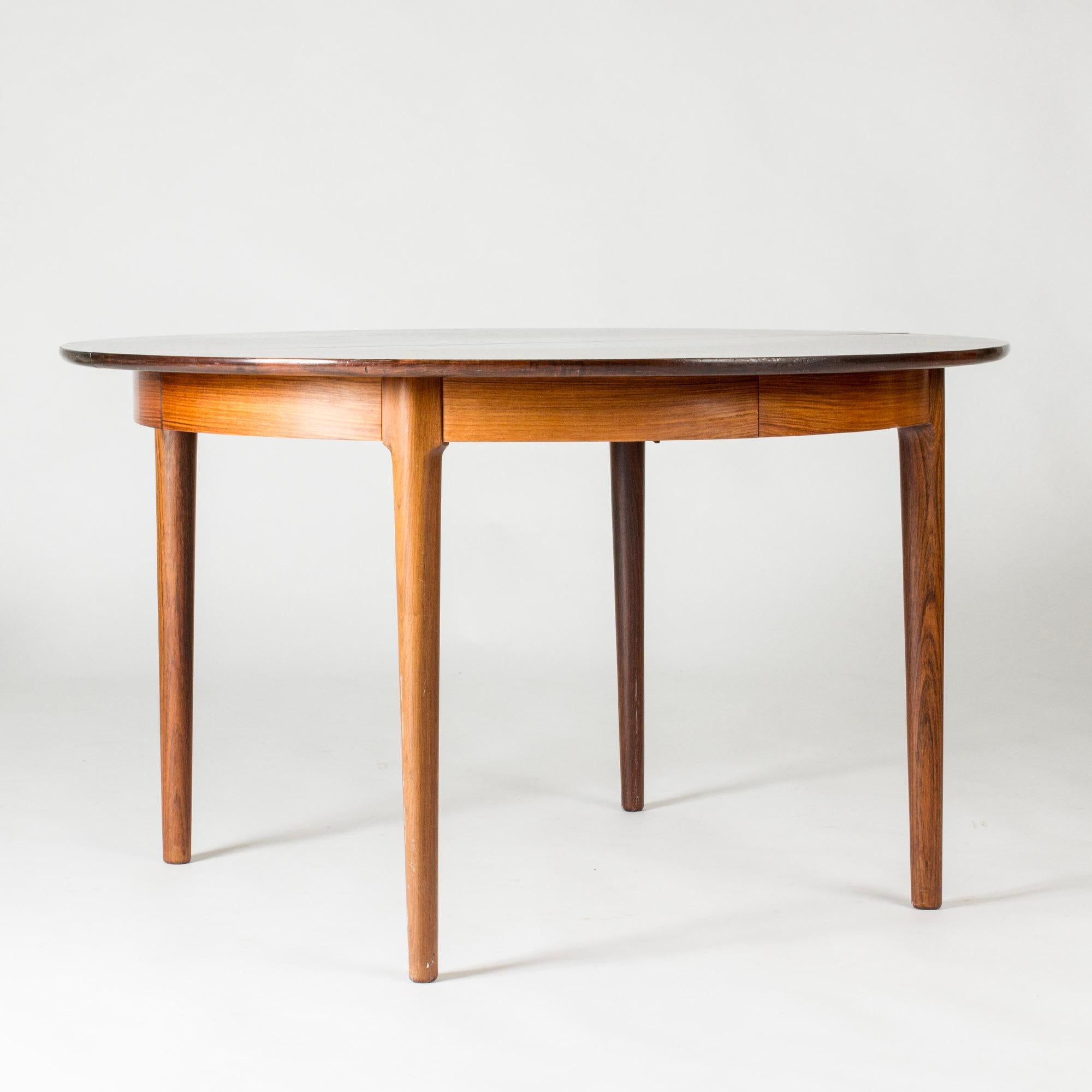 Elegant rosewood dining table by Torbjørn Afdal, sleek and versatile with beautiful rich brown veneer. A versatile table that extends from a round table for four, in an up to 360 cm long table that fits twelve people comfortably.

Width 120 cm + 55