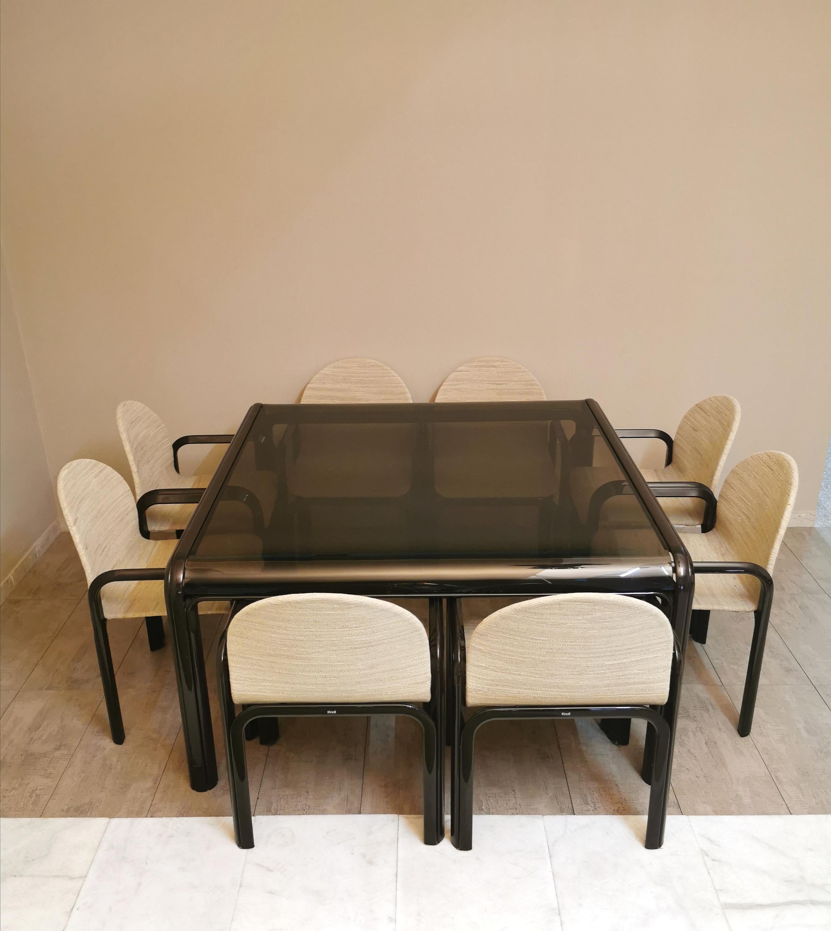 Set of 8 chairs and 1 dining table designed by the Italian designer Gae Aulenti and produced by the US company Knoll International which produces furniture items for offices and homes. The table and chairs have a brown enamelled aluminum frame. The