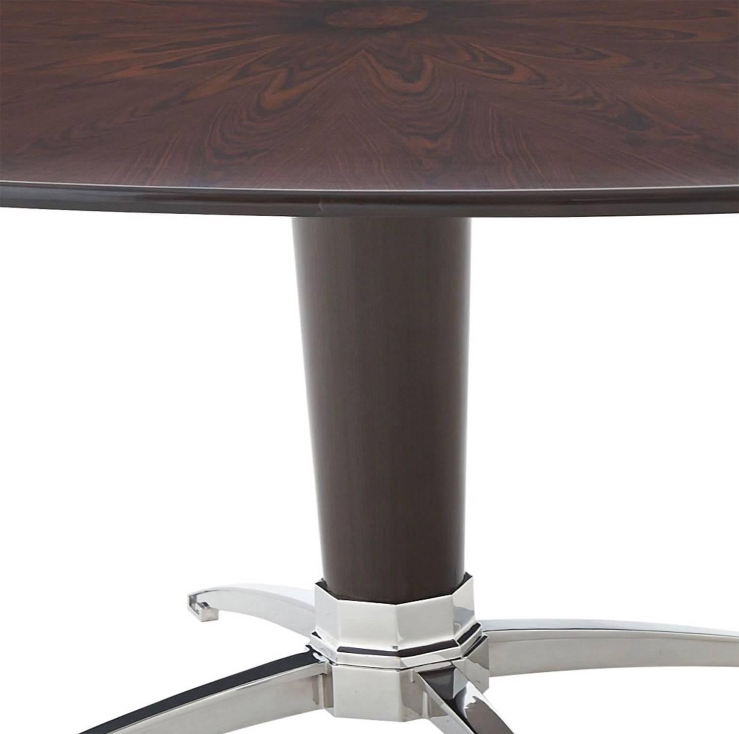 Large midcentury oval dining table with stainless steel pedestal base.

