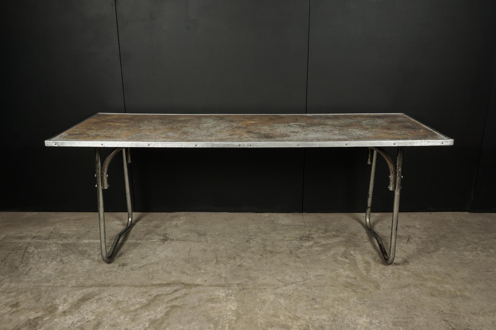 Midcentury dining table from France, circa 1960. Chrome base with a sort of nickel finish. Very nice patina on the top.