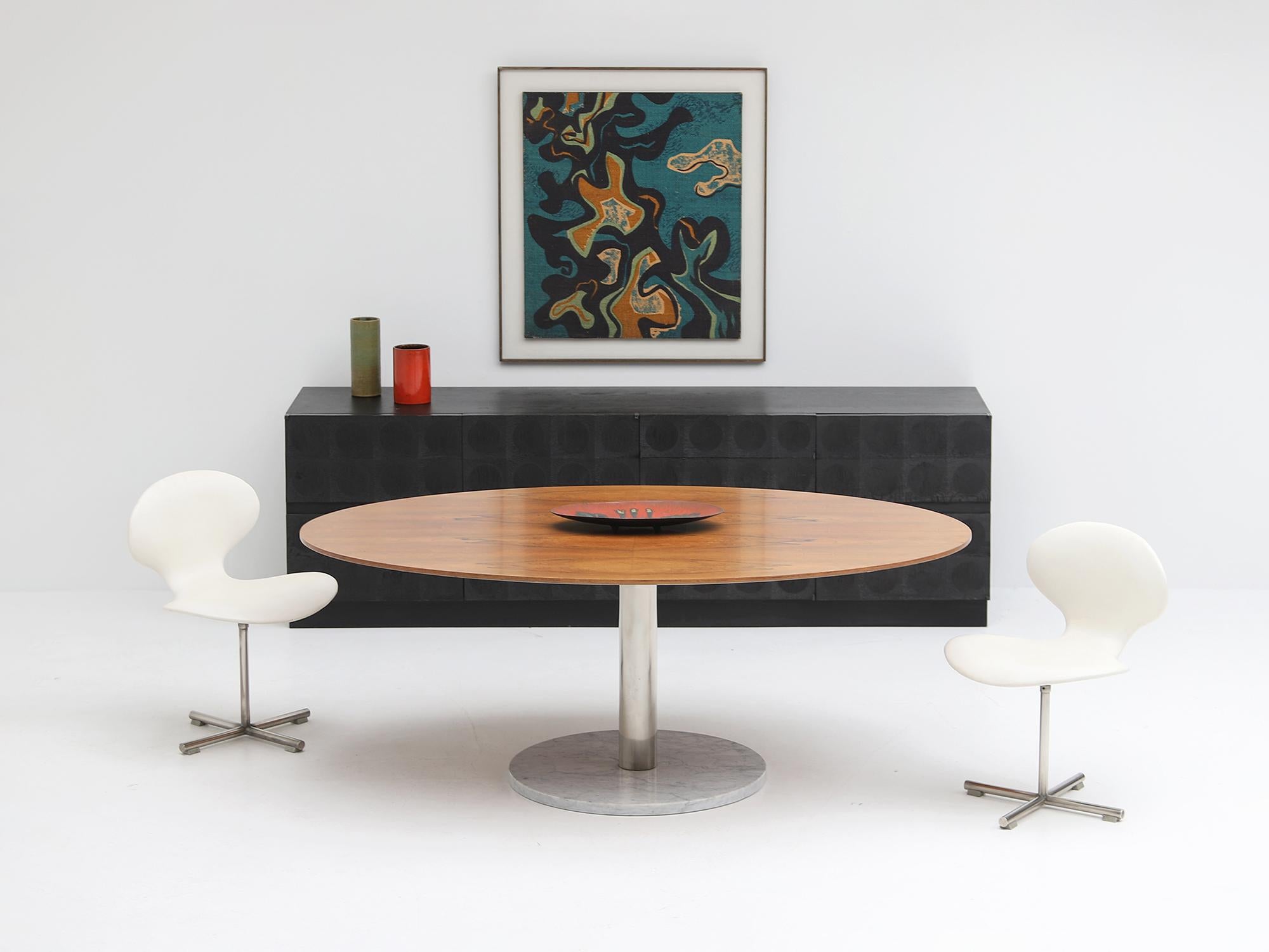 Oval dining table designed by Alfred Hendrickx in the 1960s for Belform, Belgium. The table has a veneer wooden top resting on a chromed steel and white marble base. Mostly these tables have a dark wooden top and are resting on a black marble base.