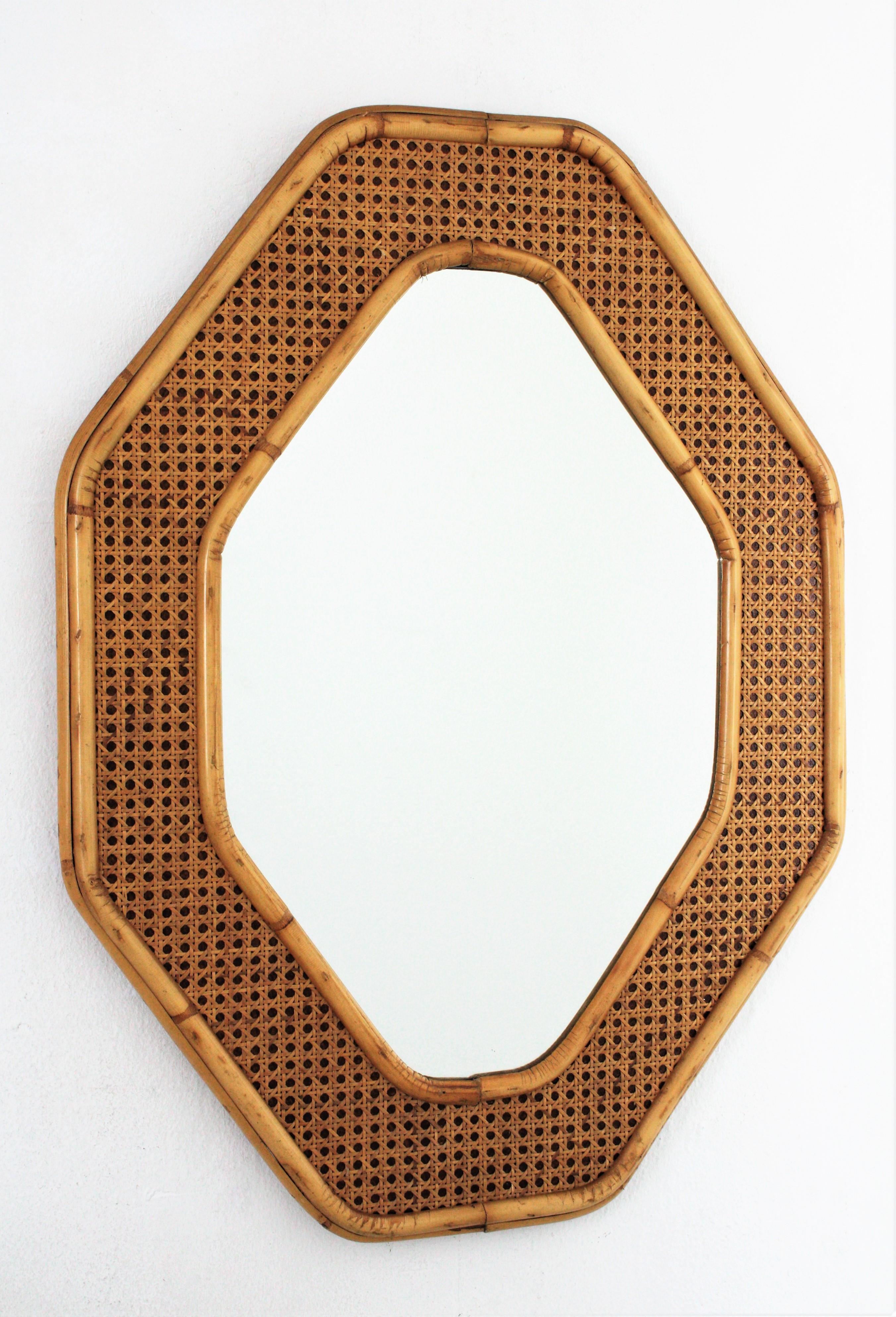 Elegant mid-20th century period woven wicker and bamboo mirror in the style of Christian Dior and Gabriella Crespi. Italy, 1970s.
This rattan/ wicker and bamboo octagonal mirror dates from the 1970s. The structure is made of bamboo, featuring a