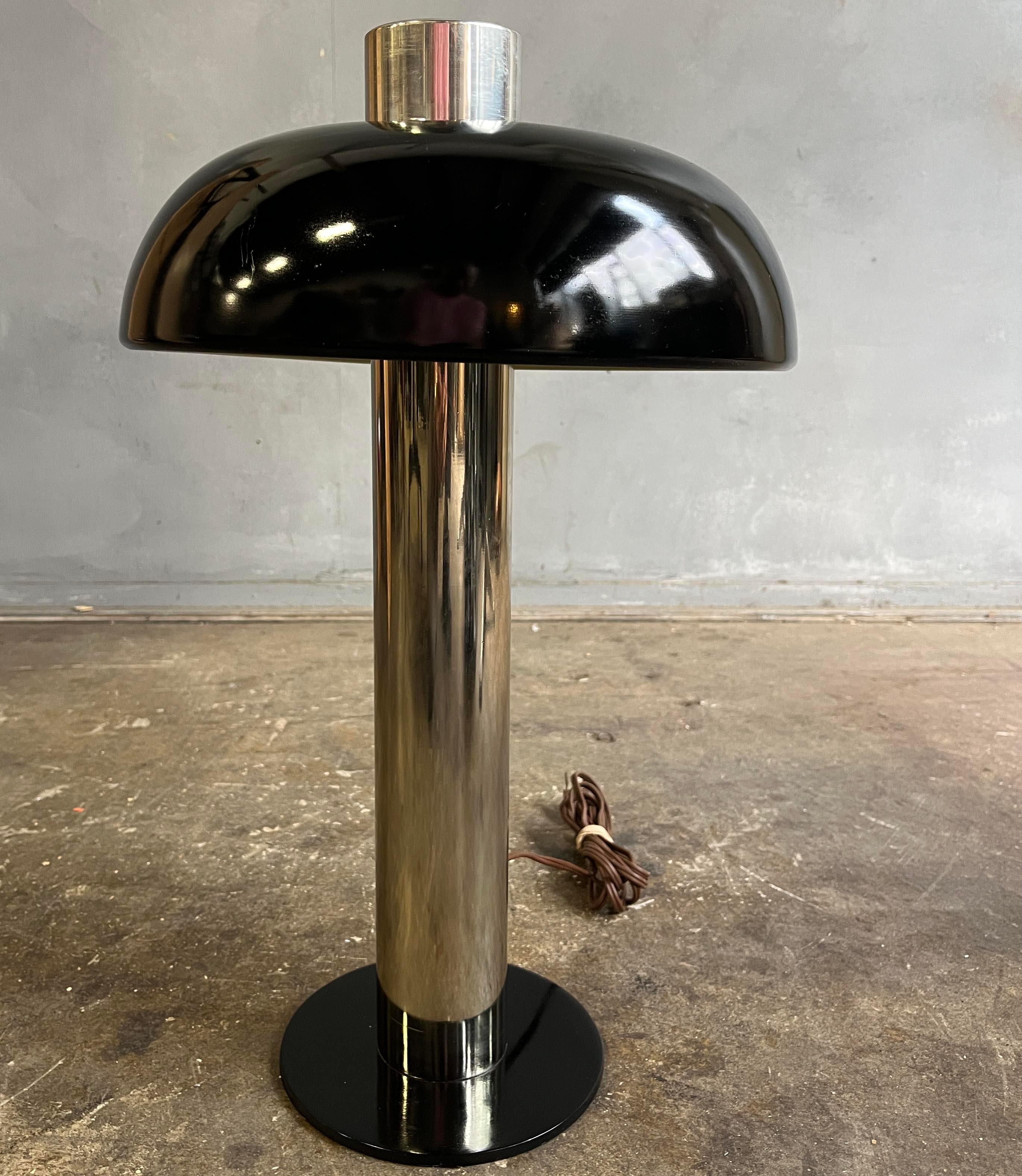 Black dome shade desk lamp having a circular hood offset shade, not centered on the vertical column, and on a chrome column and circular base, by Laurel Lamp Co., American 1960s. Original, clean and working condition. 

Height 18 in, diameter of