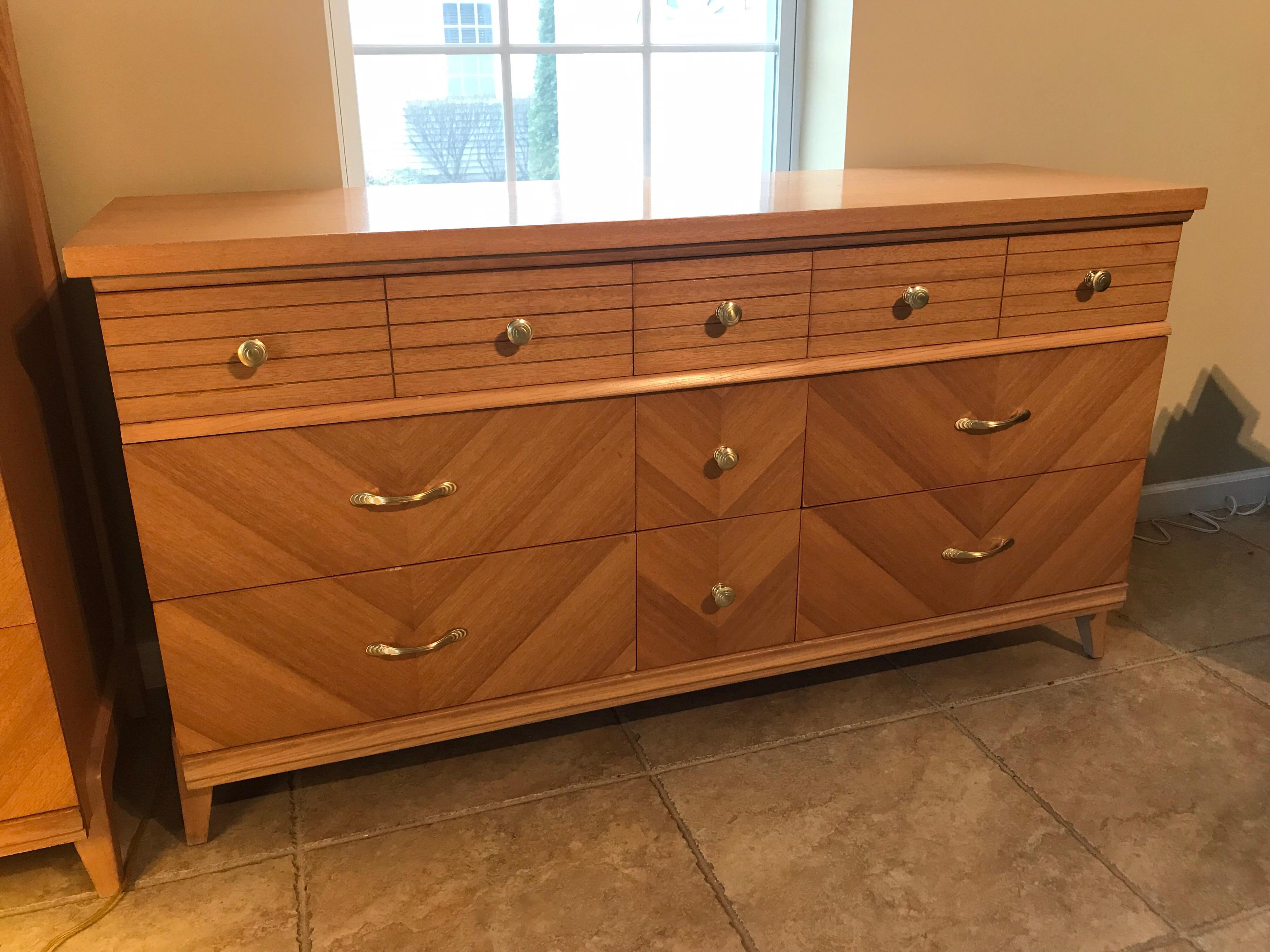 Pale bookmatched veneered double dresser, 1960s

Measures: 5’ wide x 18 3/4 deep x 32.25 “ high

Top drawer chairs:
Side drawers 23” wide 
Middle drawer 9” wide 
5” deep.

Middle and Bottom Drawers:
Side drawers 23” wide 
Middle drawers