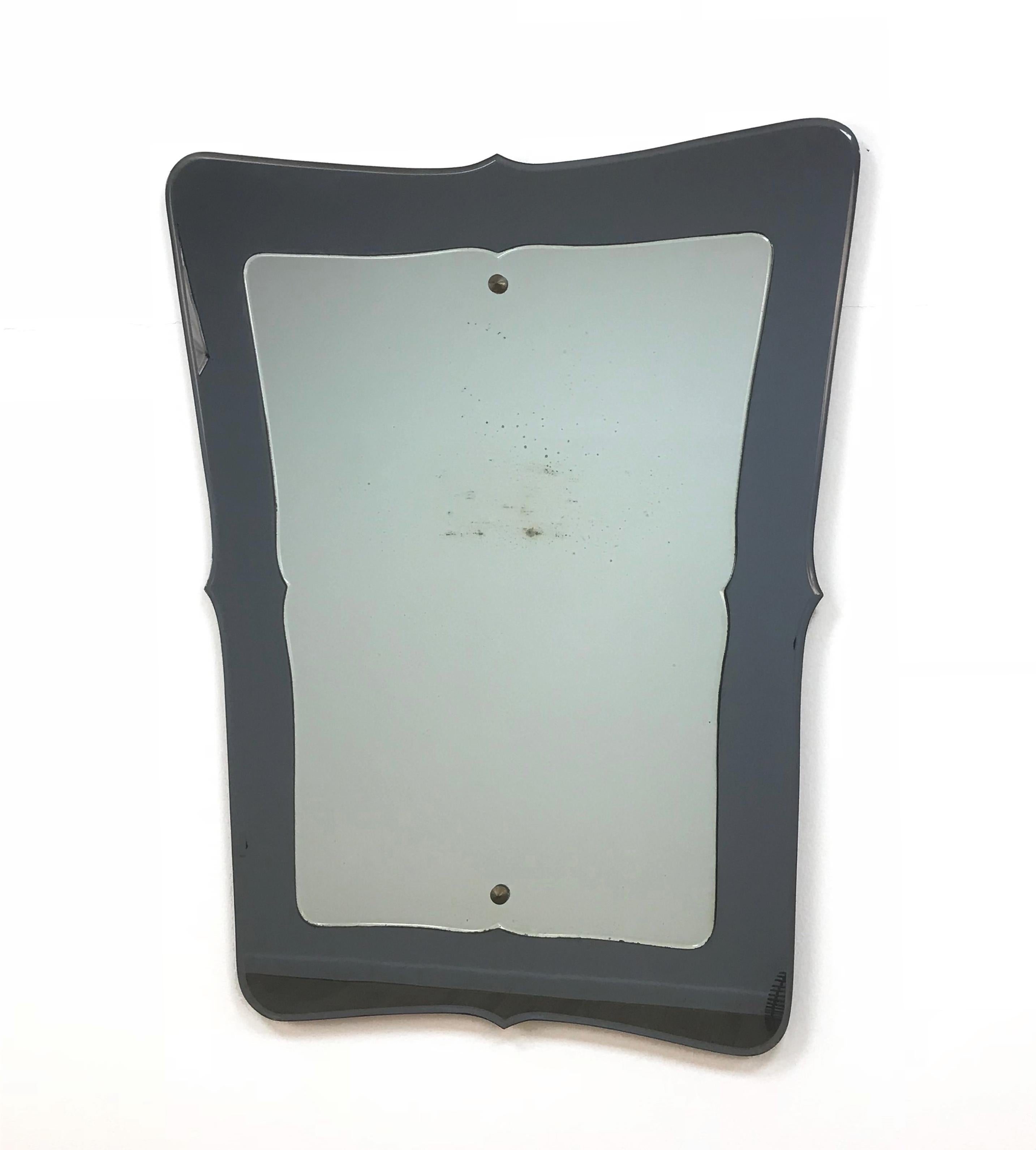 Unique and large midcentury double-layered wall mirror. It was produced in Italy during 1950s and it's clearly in the style of Fontana Arte.

It is very rare as it has two layers of mirrors, a crystal and a darker one, another astonishing element