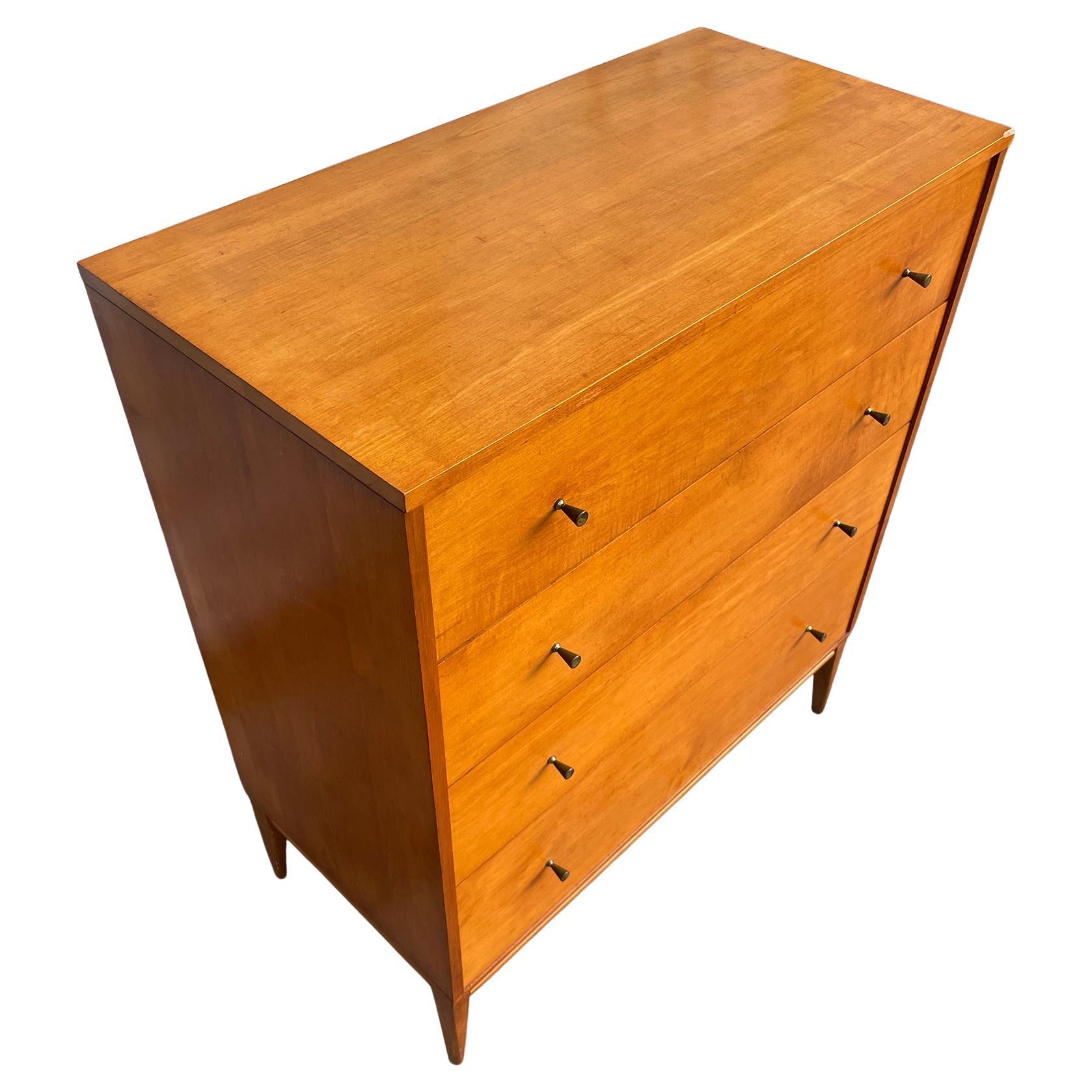 Beautiful Mid century tall 4-drawer dresser by Paul McCobb circa 1950 Planner Group #1501 with 4 center drawers. Solid maple construction has a beautiful Medium Blonde original Finish. All original brass cone pulls polished. Sits on 4 solid maple