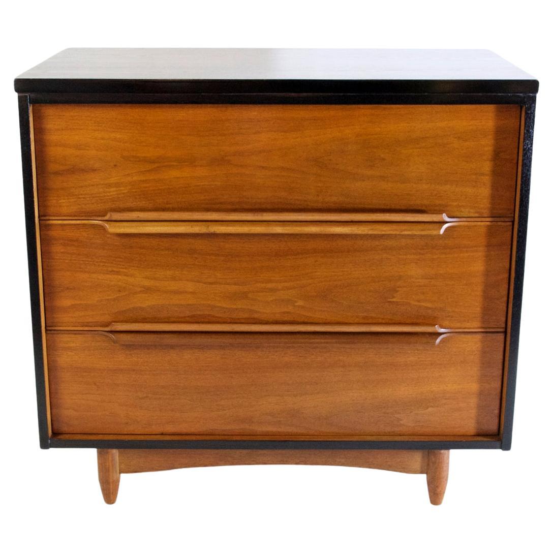 An elegant dresser in teak with an ebonized frame. It has four spacious drawers with handles that are incorporated curved handles. In very nice restored condition and of high quality production.