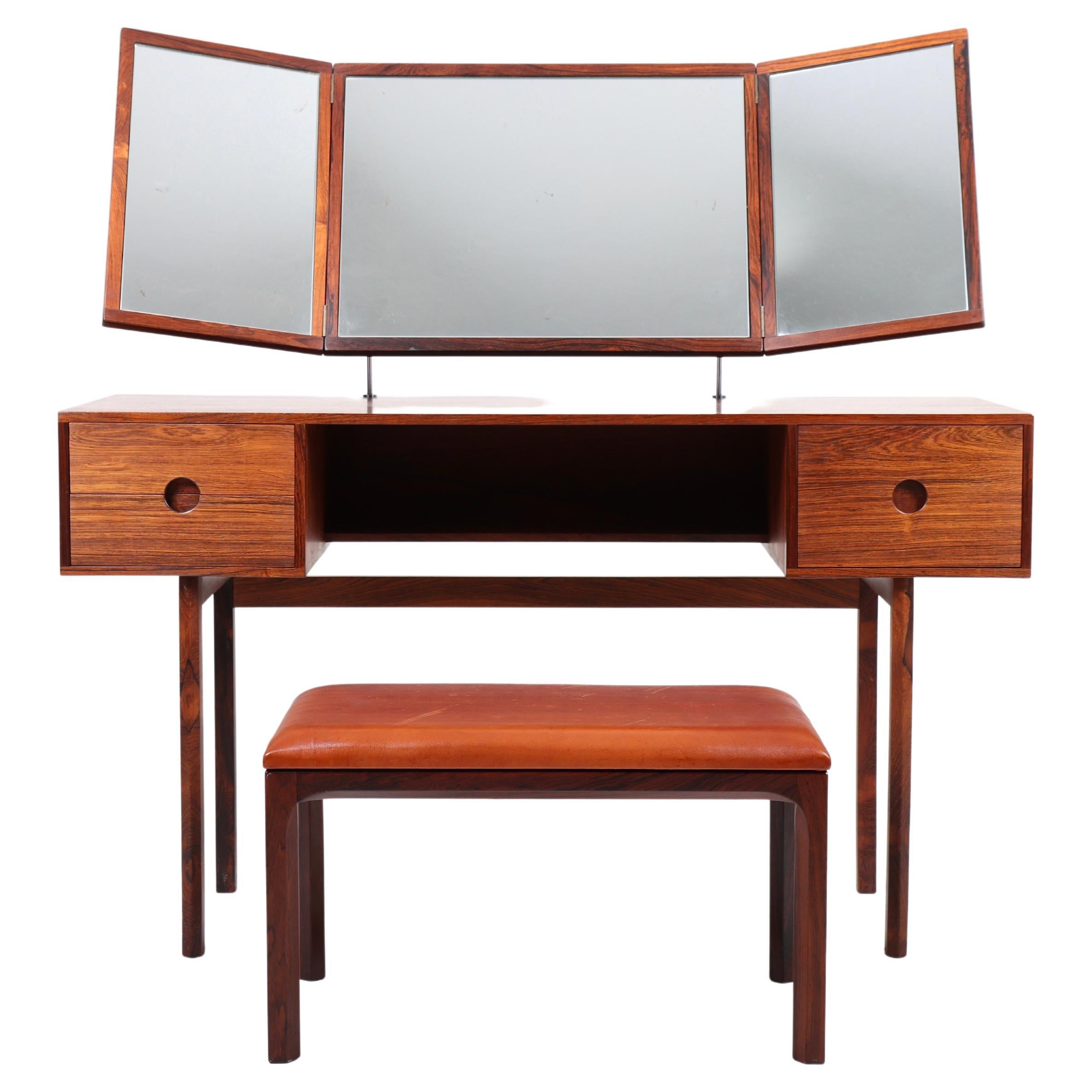Dressing table in rosewood with matching stool in patinated leather. Designed by Kai Kristiansen and made by Aksel Kjærsgaard in the 1960s. Great condition.