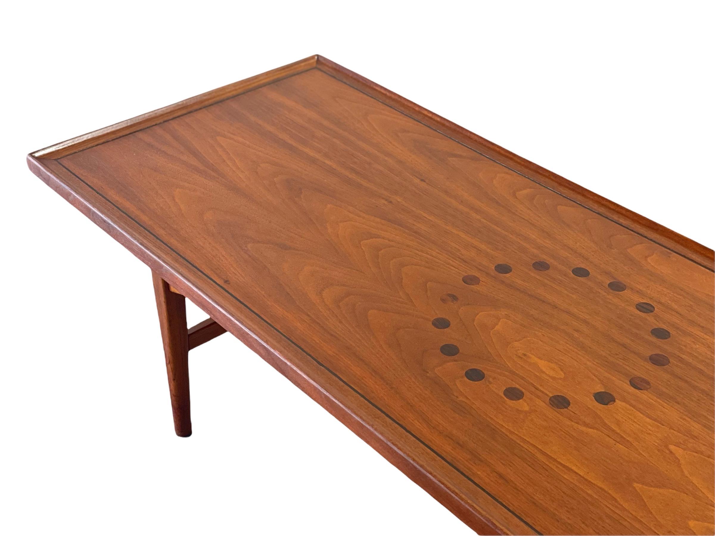 Mid-Century Modern Declaration cocktail table by Kipp Stewart and Stewart MacDougall for Drexel. Surfboard style - constructed of American walnut with a Brazilian rosewood inlay. Subtle, modern and timeless. Danish modern style with stout and sturdy