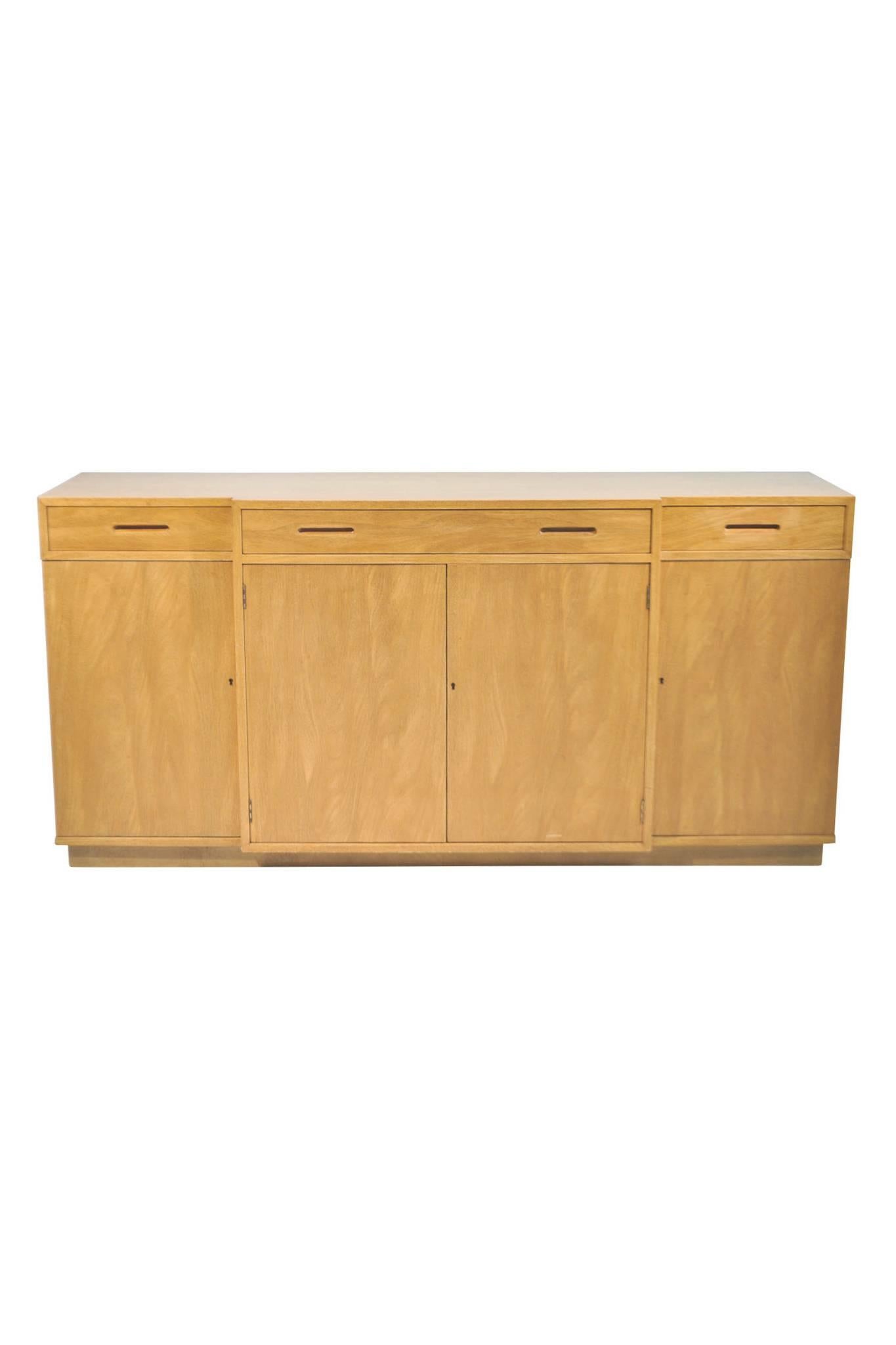 This exceptional sideboard was designed by Edward Wormley for Dunbar Furniture's New World Collection. Wormley's modernist design can be characterized as making use of simple surfaces and silhouettes while exemplifying fine woodwork. 

This