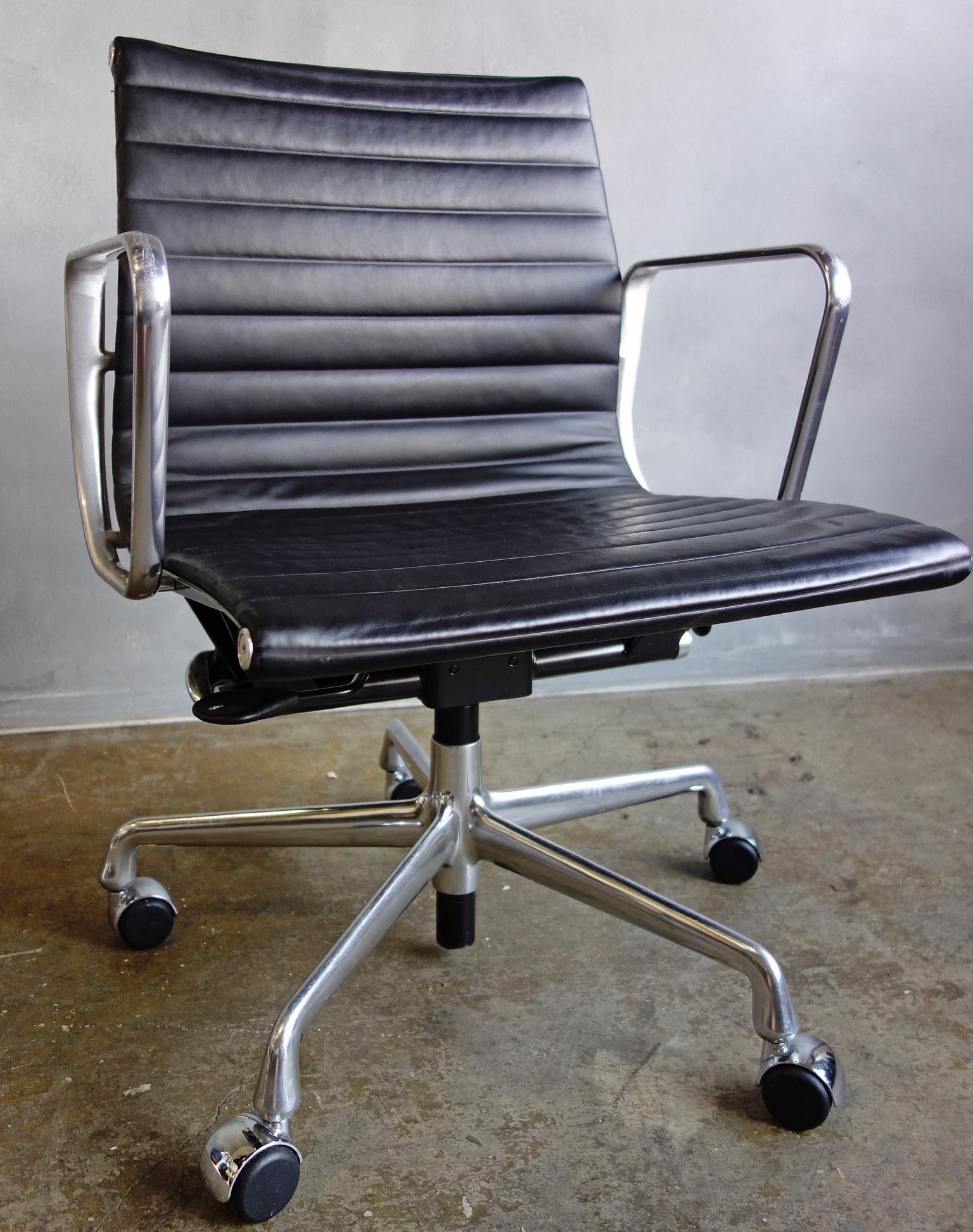 For your consideration are up to 10 midcentury Eames side chairs upholstered in black leather. Elegance and comfort separates this iconic chair from the rest. The leather is in good condition with the arms having some scratches and dings typical of