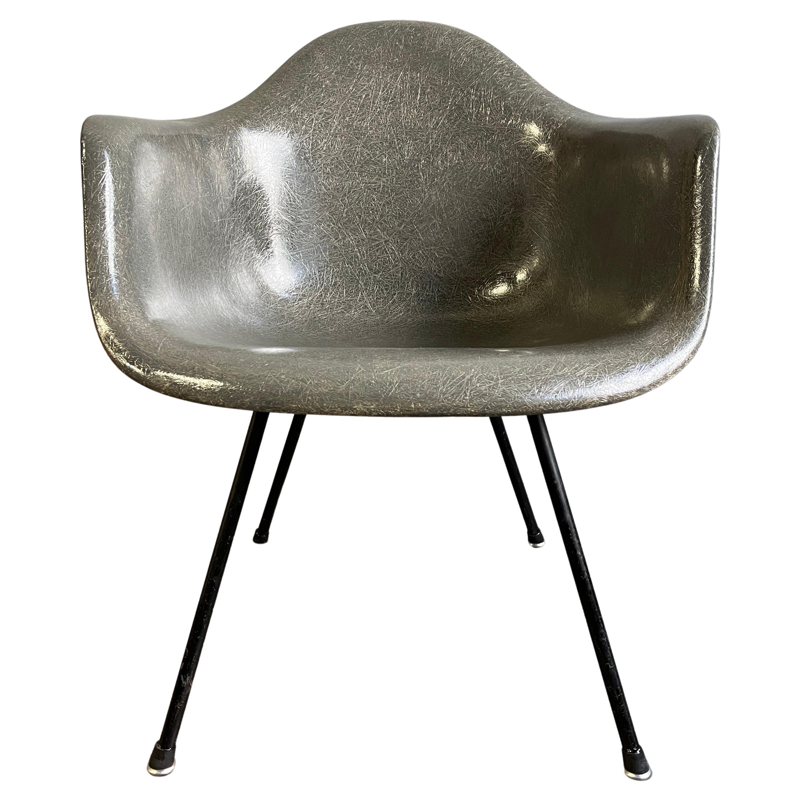 Gorgeous early Eames for Herman Miller fiberglass chair LAX (Low Armchair on X Base) having large shock mounts and flat edge shell. All original and structurally sound. Elephant hide gray. The most iconic design in Mid-century modern history. 

   