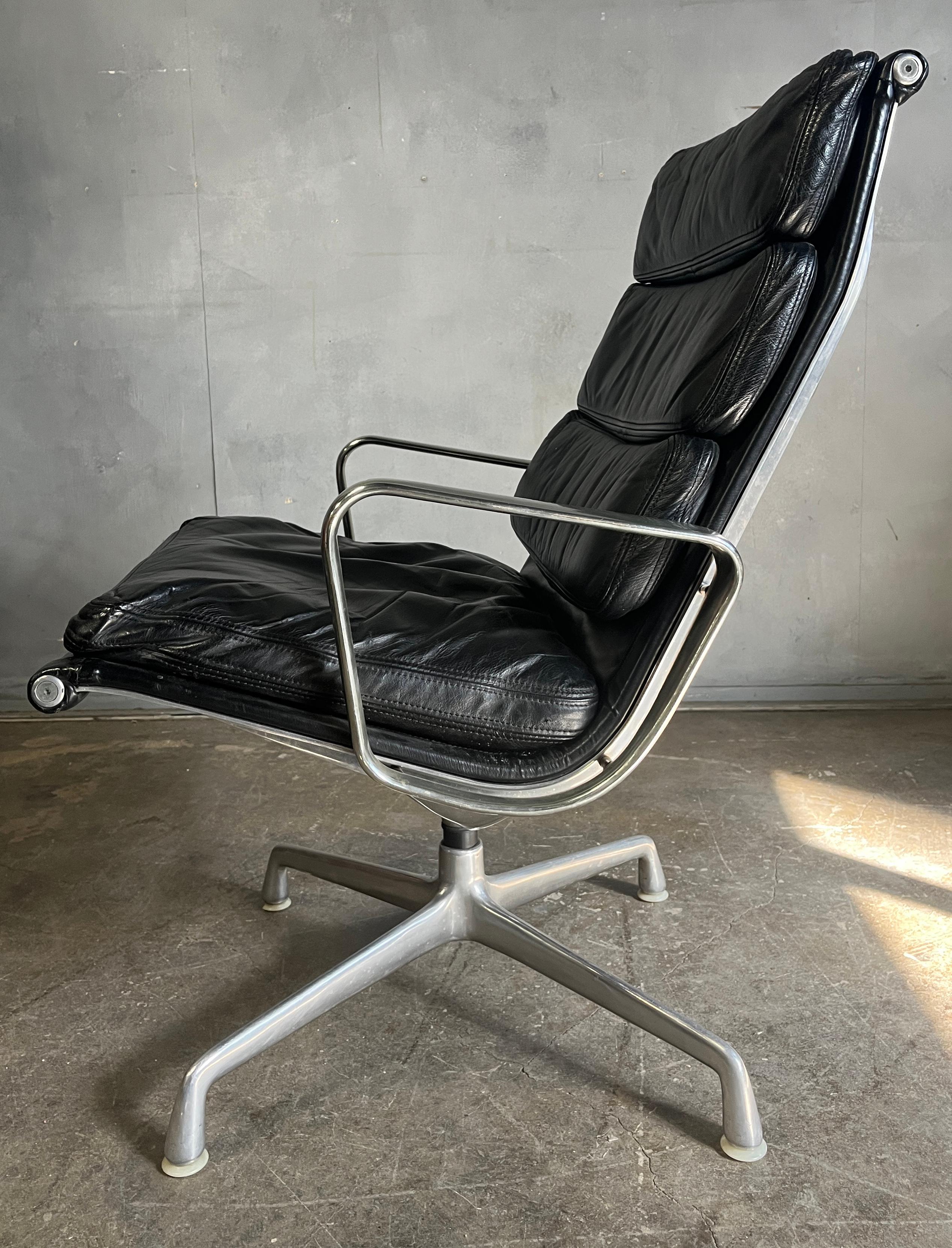 Eames black leather swivel soft pad lounge chair EA 216 by Eames for Herman Miller. Early edition in cast aluminium (not chrome). Original glides. Gorgeous wool back. Very nice patina and aluminum is great shape. Casting stamp dates this chair early