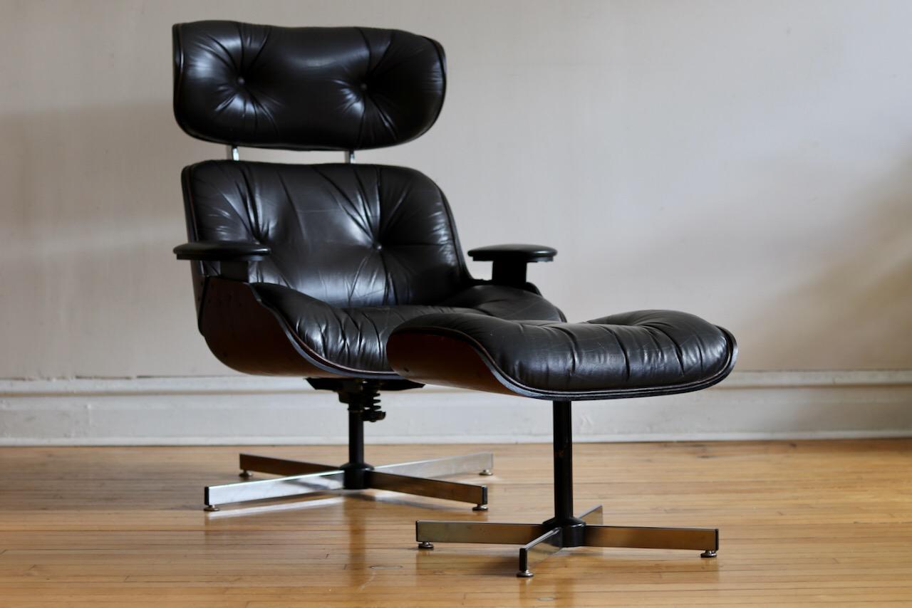 Mid-Century Modern 1970s production Eames style lounge chair and ottoman. 
Chrome base, walnut bent plywood and black faux leather upholstery. 
Chair has some flex to it and is very comfortable. 
Very slight patina and wear.
Excellent vintage