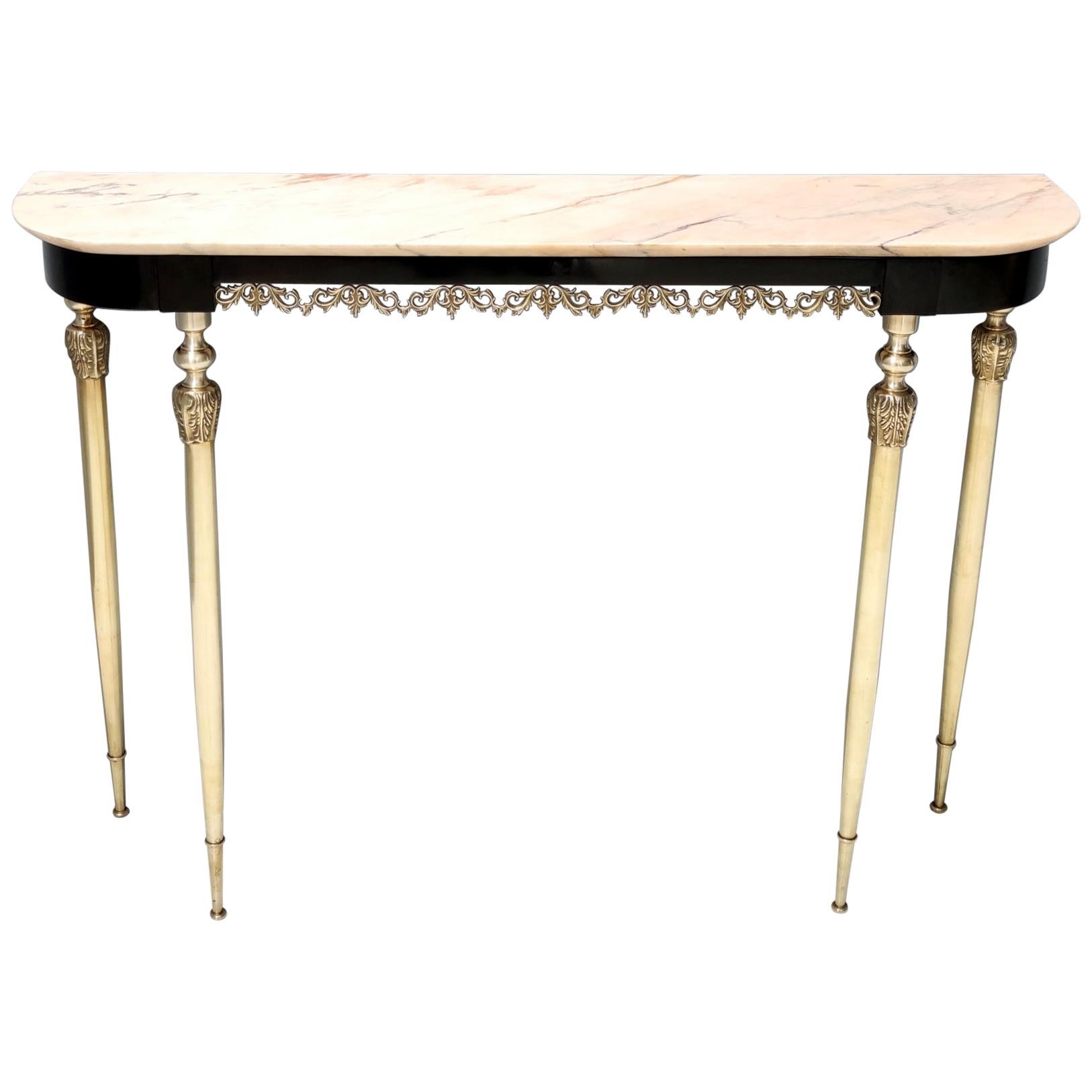 Made in Italy, 1960s.
This console table features a veined Portuguese pink marble top, an ebonized beech frame and brass details.
It is a vintage item, therefore it might show slight traces of use, but it can be considered as in very good original