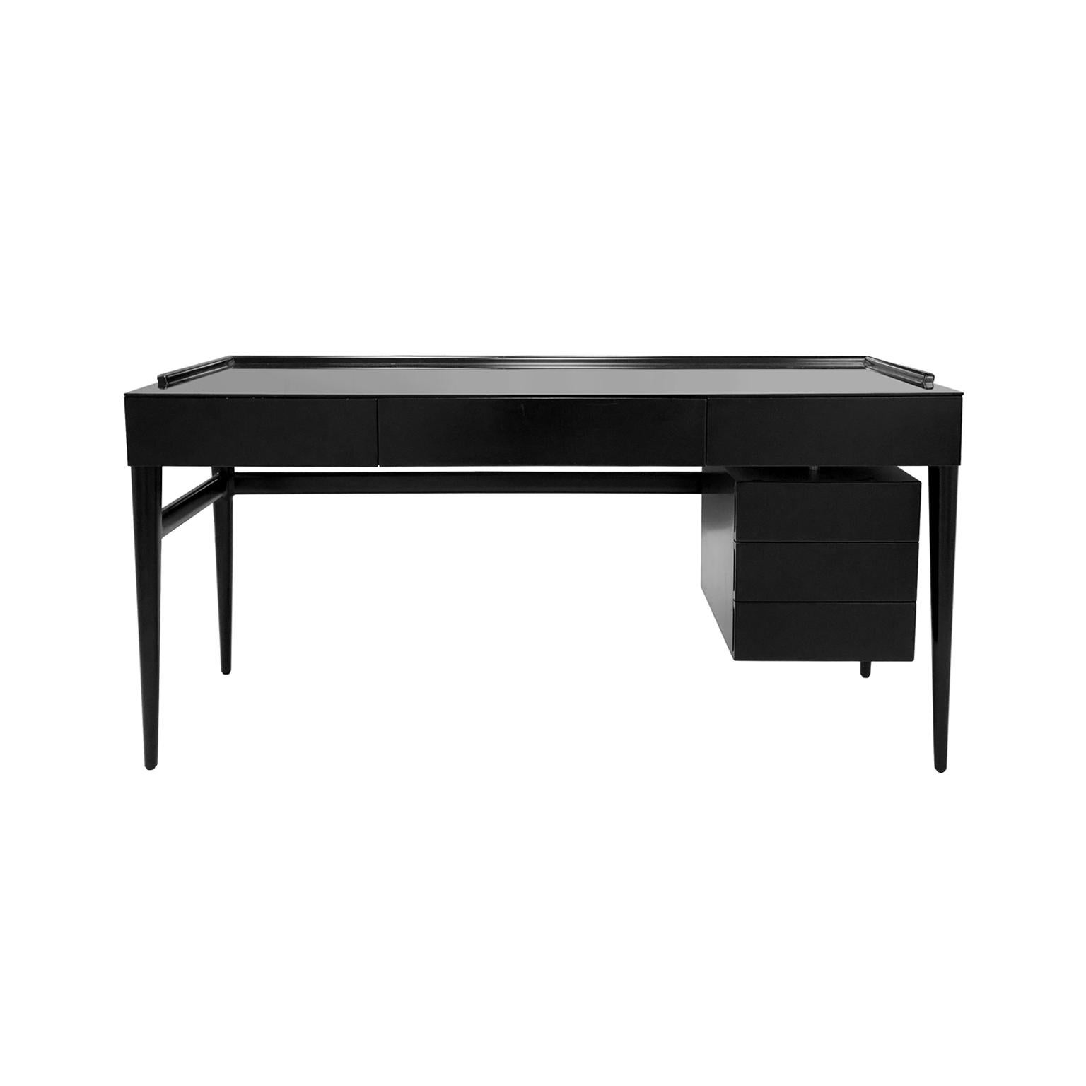 Midcentury ebonized wood desk with drawers and glass top in the manner of Gio Ponti. Italy, 1950s.